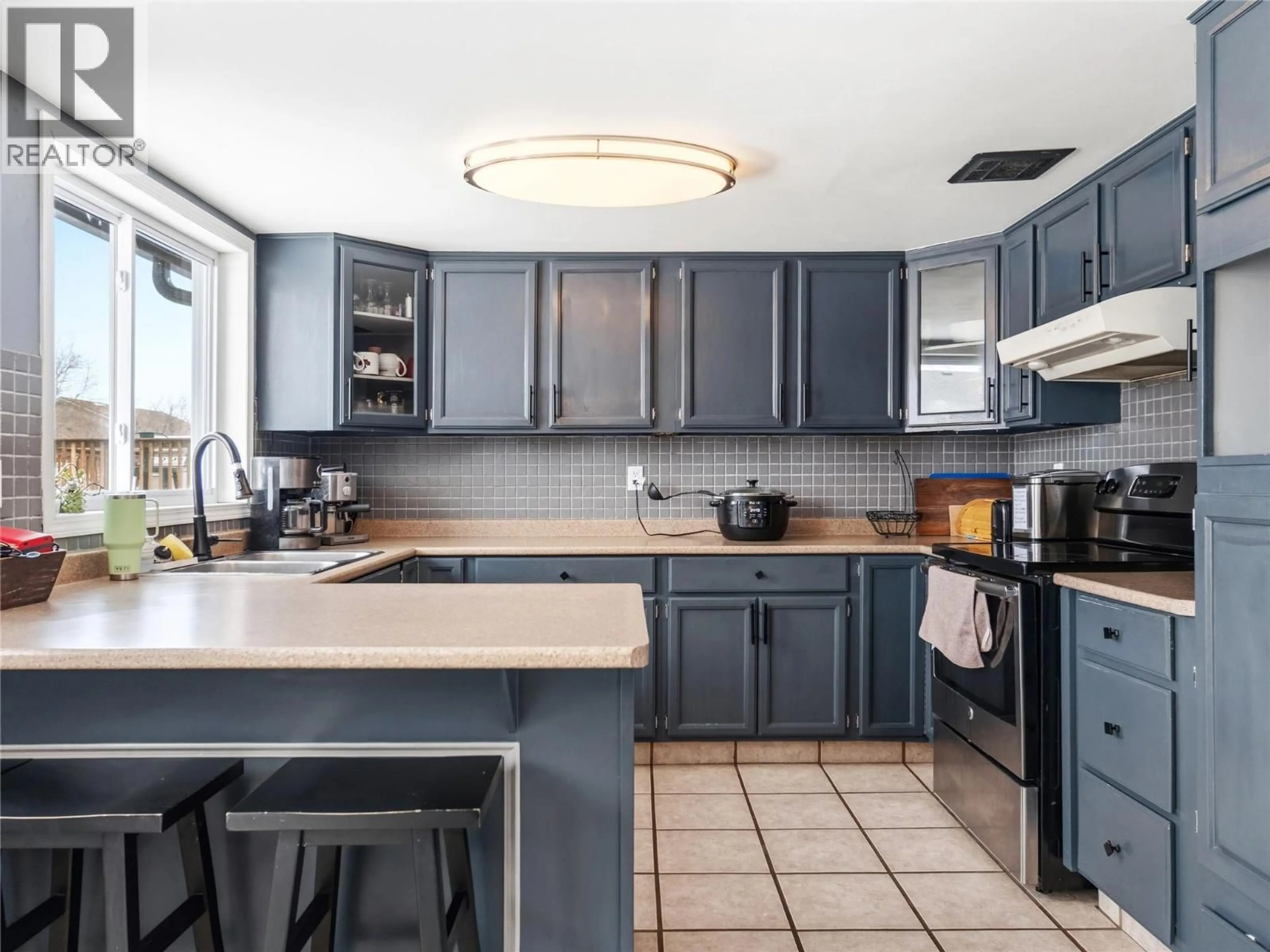 Open concept kitchen, ceramic/tile floor for 10718 CYPRUS COURT, Dawson Creek British Columbia V1G2N4