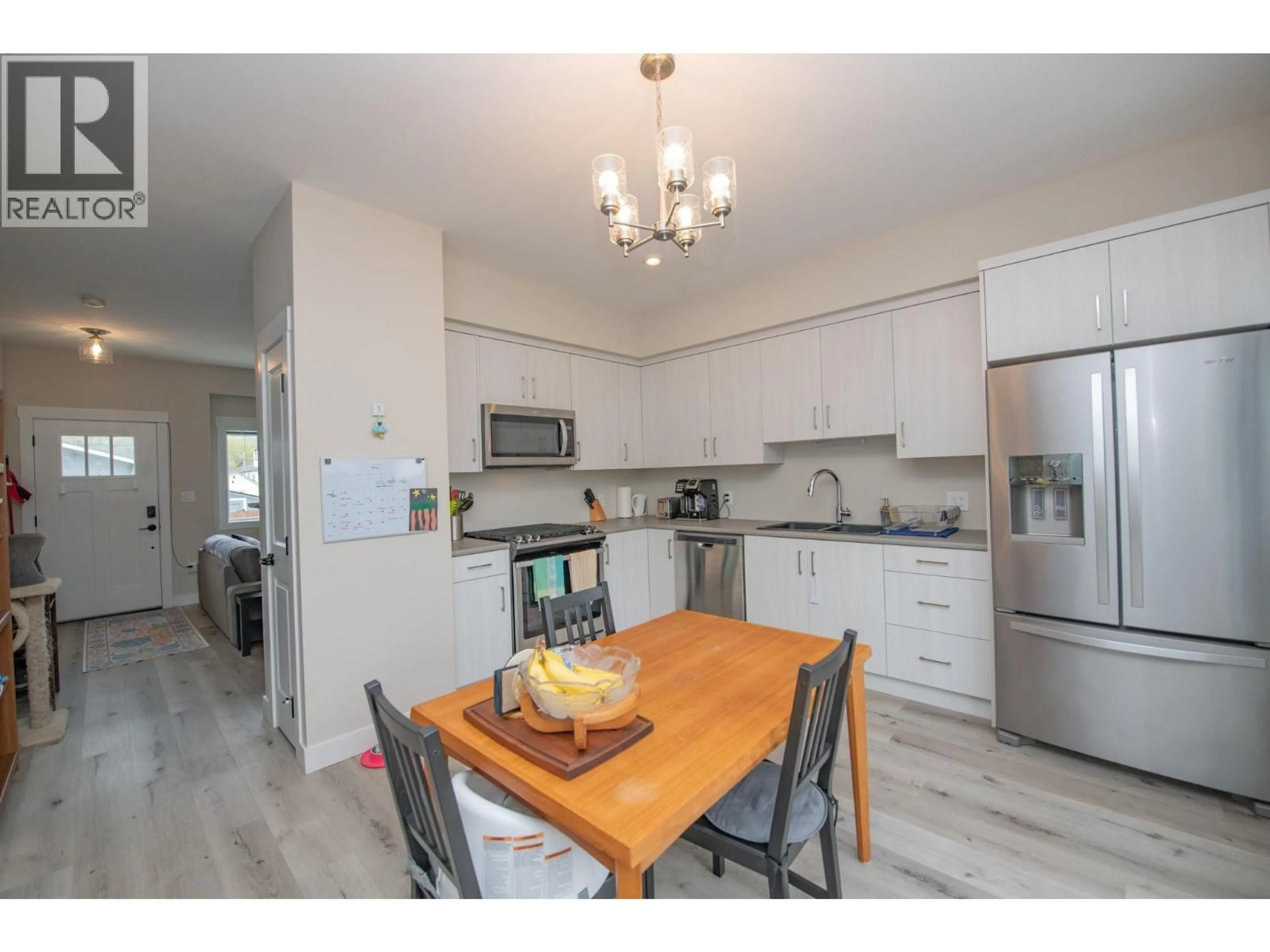 Open concept kitchen, wood/laminate floor for 103 - 4002 30 AVENUE, Vernon British Columbia V1T2G3