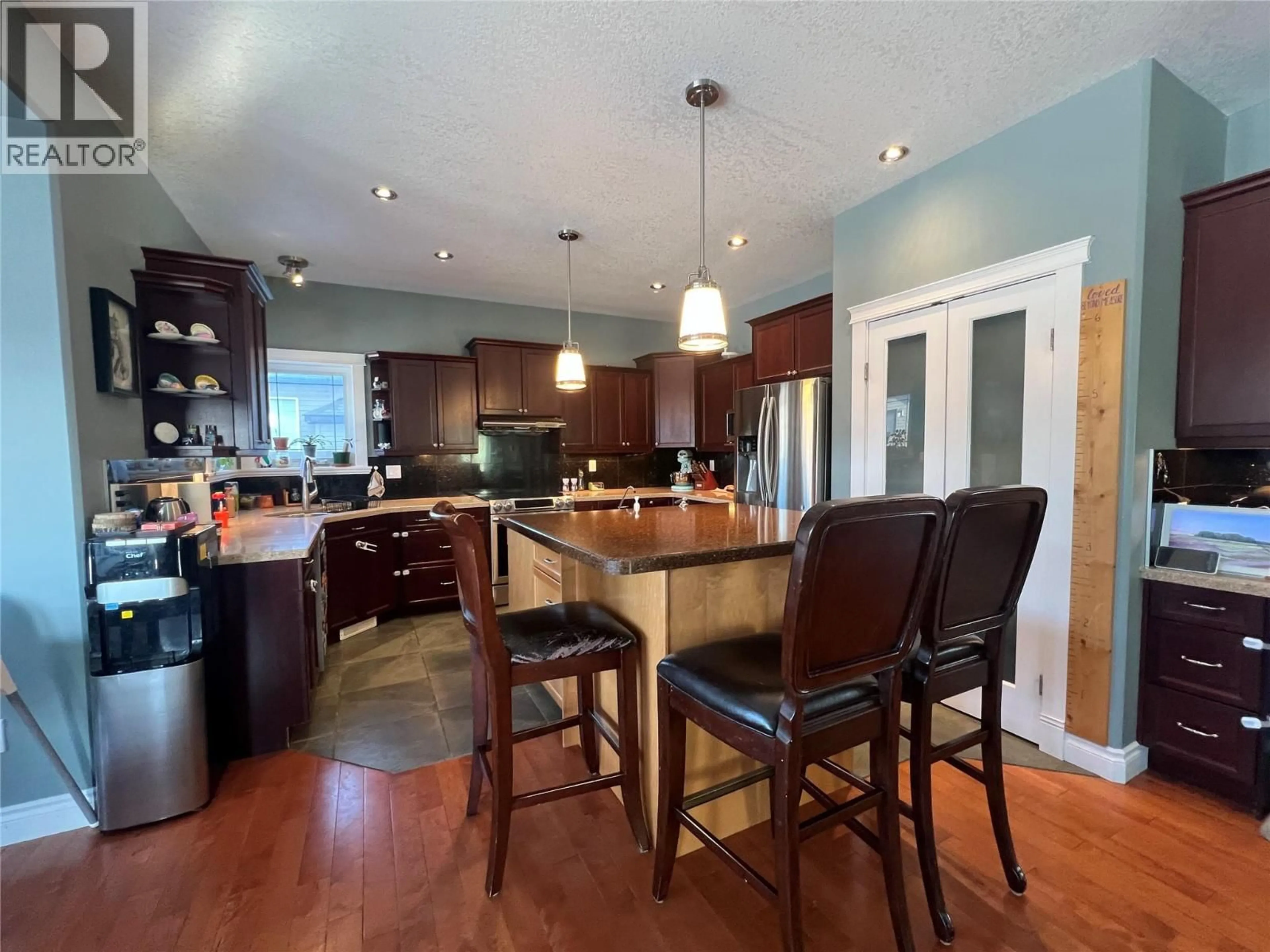 Open concept kitchen, wood/laminate floor for 1844 88 AVENUE, Dawson Creek British Columbia V1G0A6