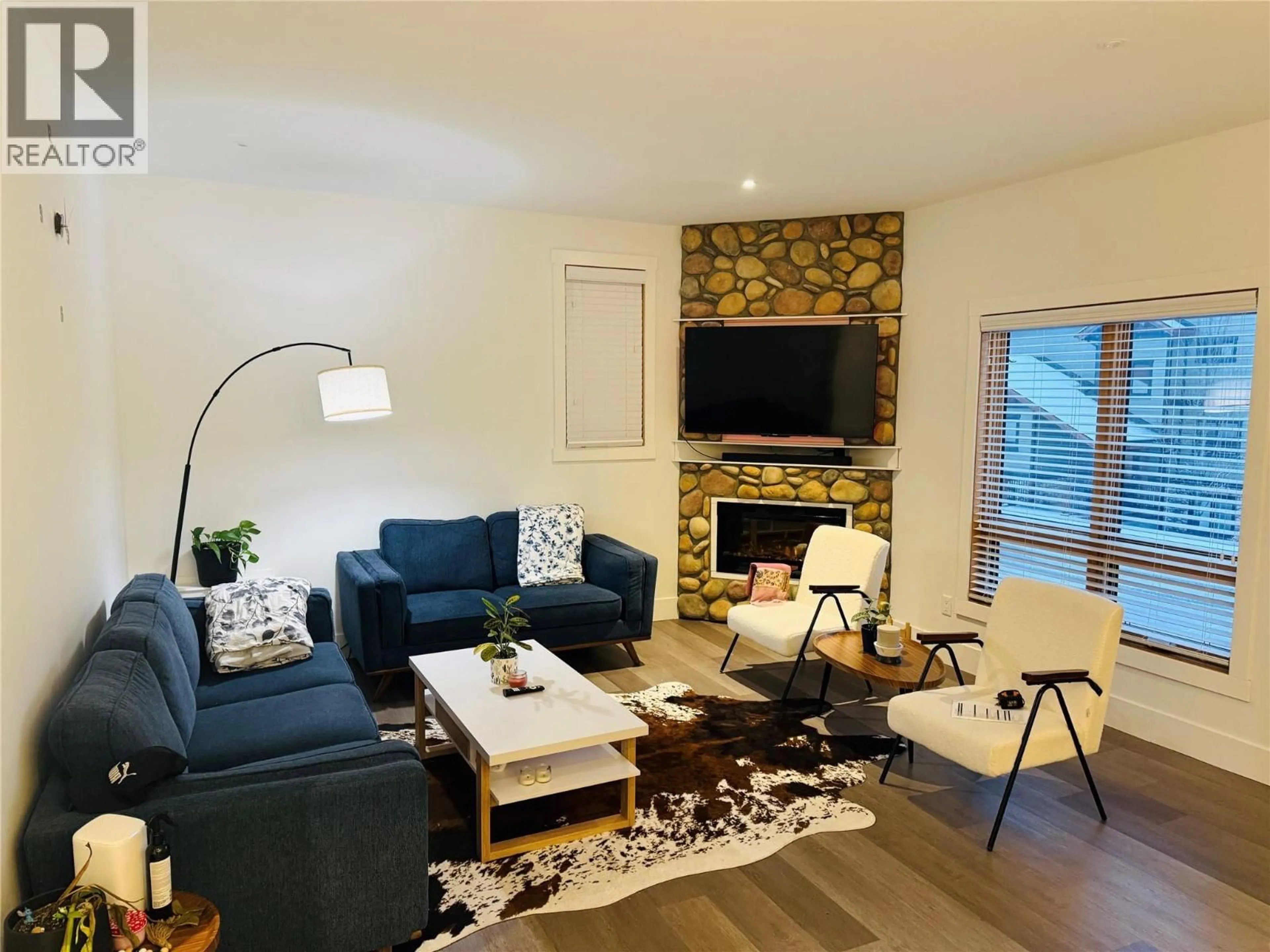Living room with furniture, wood/laminate floor for 501 - 7291 PROSPECTOR AVENUE, Radium Hot Springs British Columbia V0A1M0