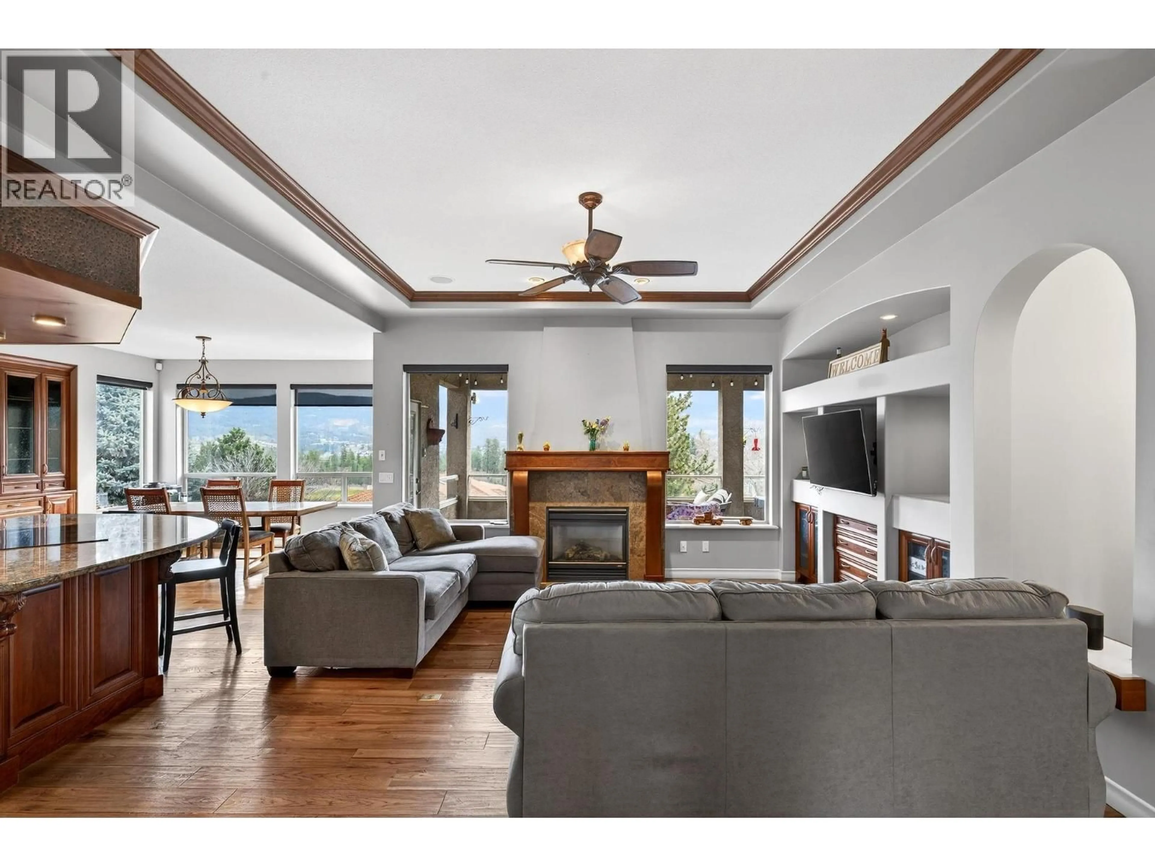 Living room with furniture, wood/laminate floor for 2288 CAPISTRANO DRIVE, Kelowna British Columbia V1V2A2