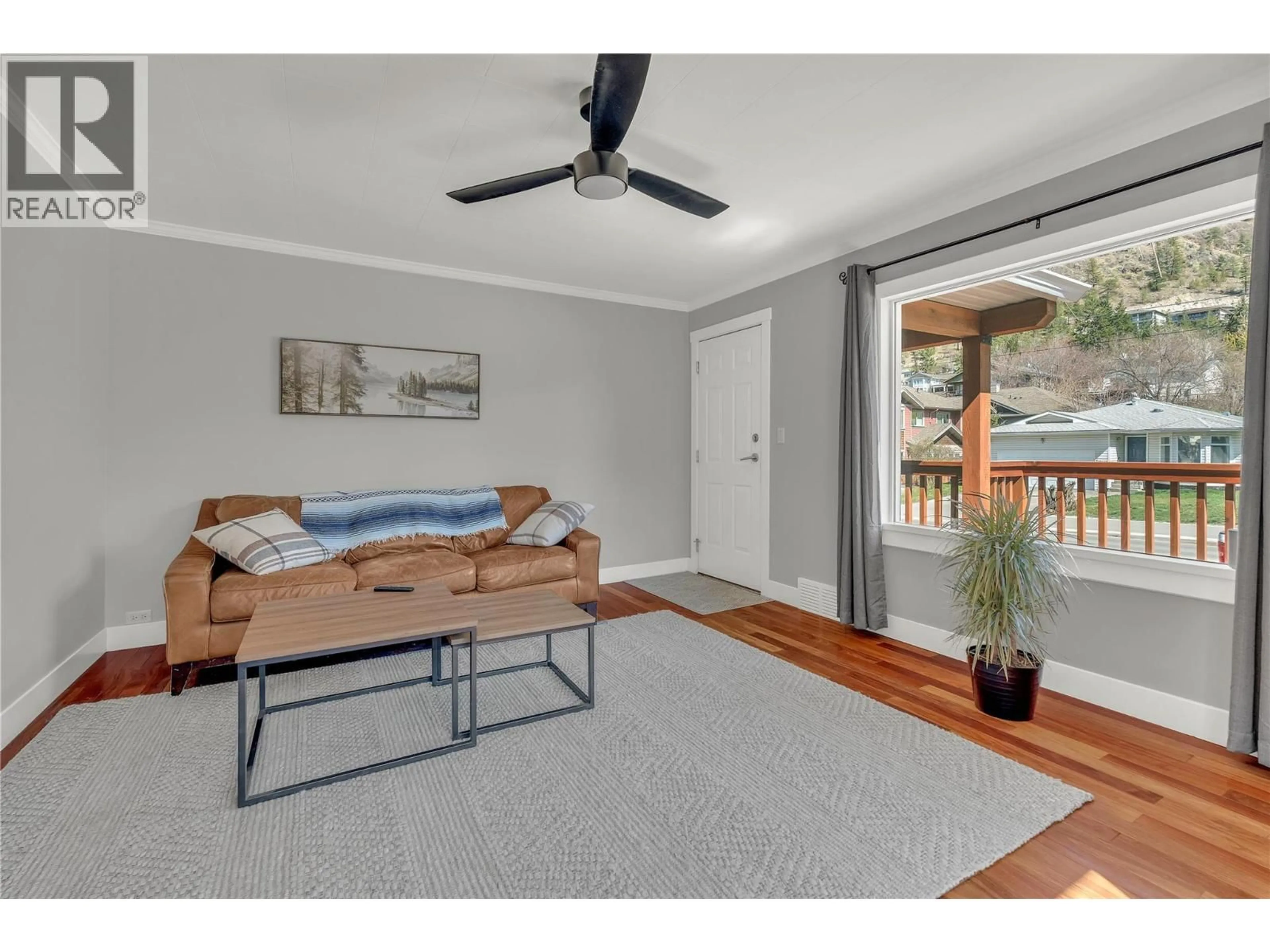 Living room with furniture, wood/laminate floor for 10602 VICTORIA ROAD SOUTH, Summerland British Columbia V0H1Z2