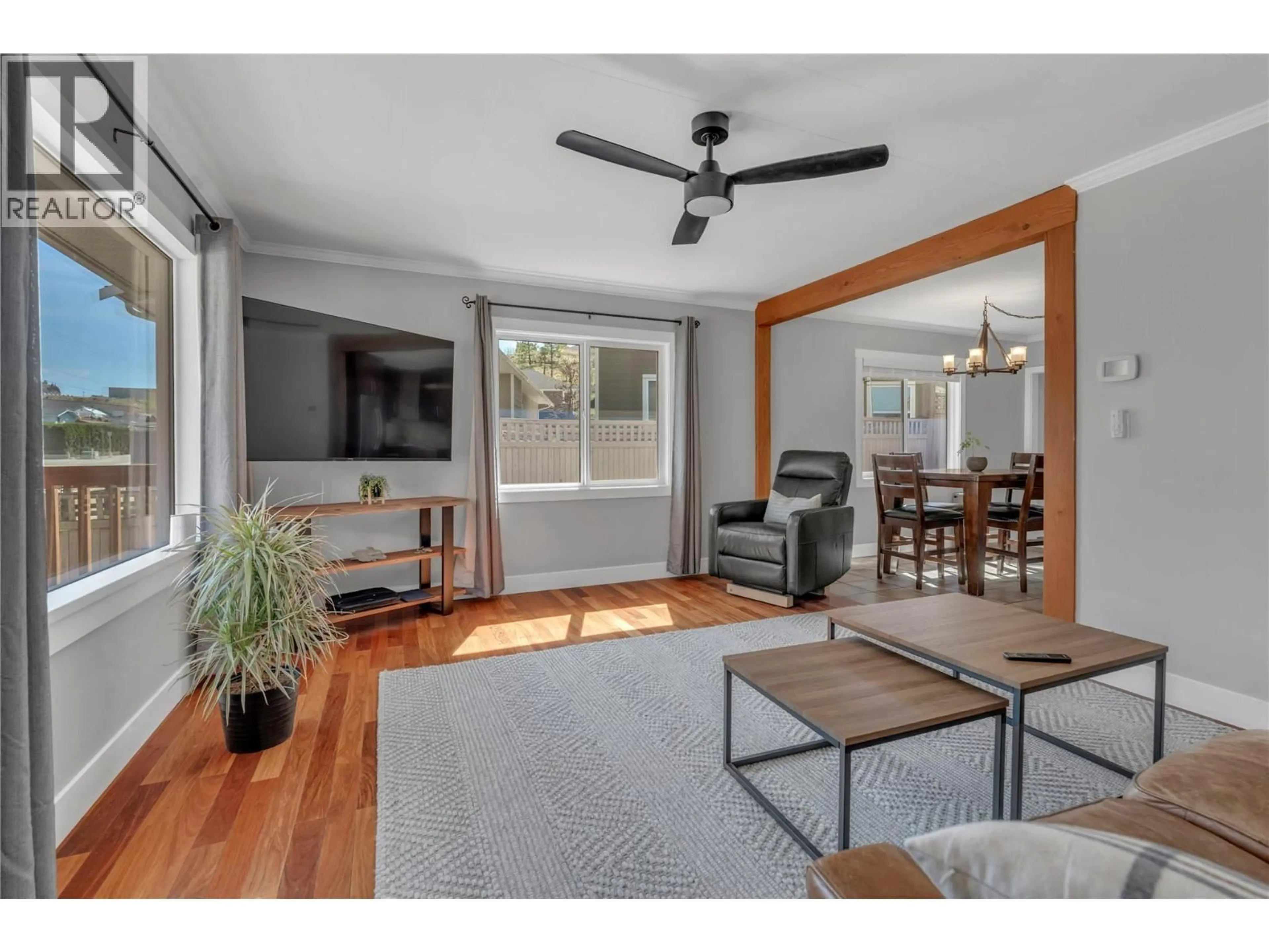 Living room with furniture, wood/laminate floor for 10602 VICTORIA ROAD SOUTH, Summerland British Columbia V0H1Z2