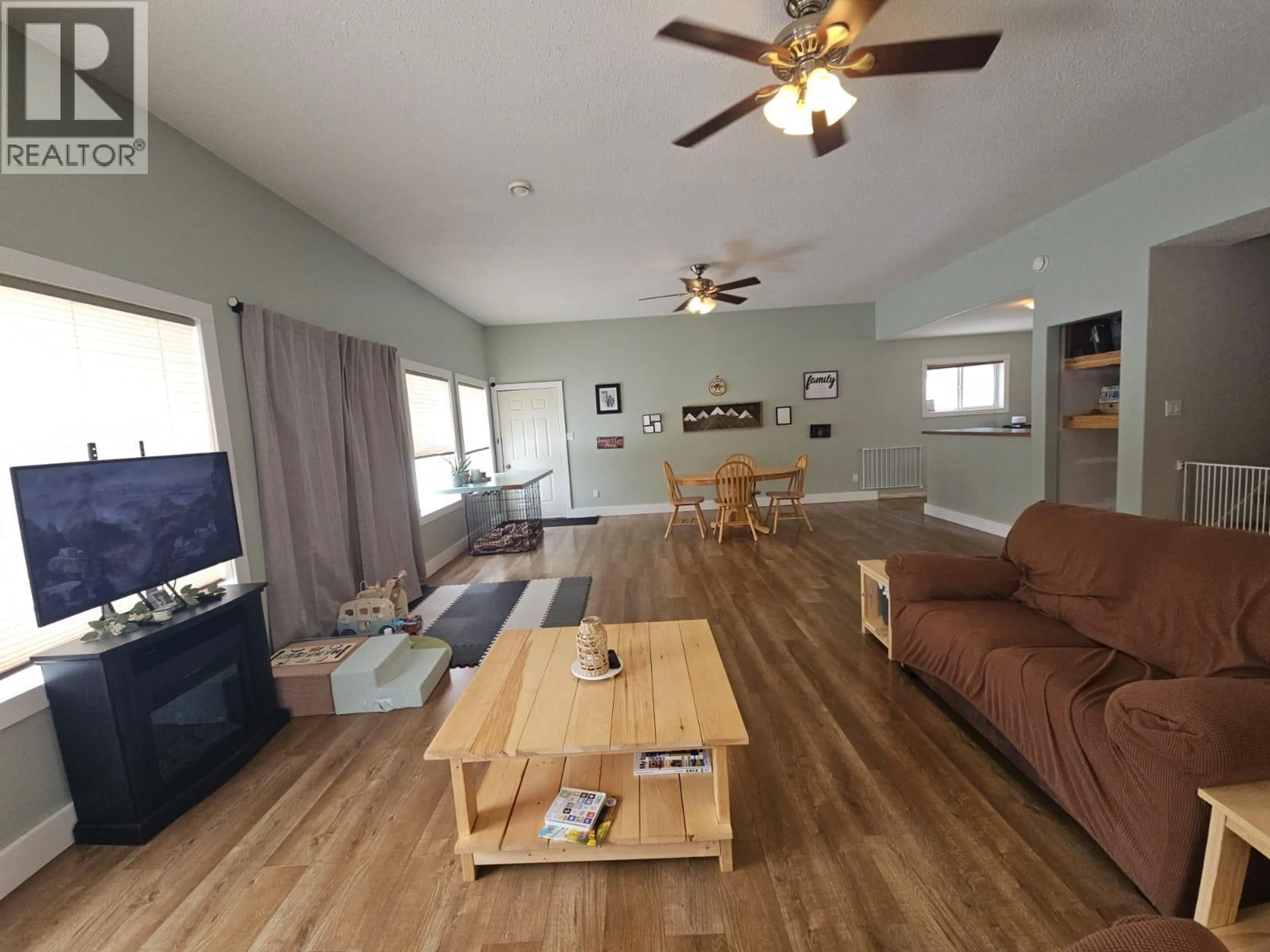 Living room with furniture, wood/laminate floor for 5746 97 HIGHWAY, Dawson Creek British Columbia V1G0J3