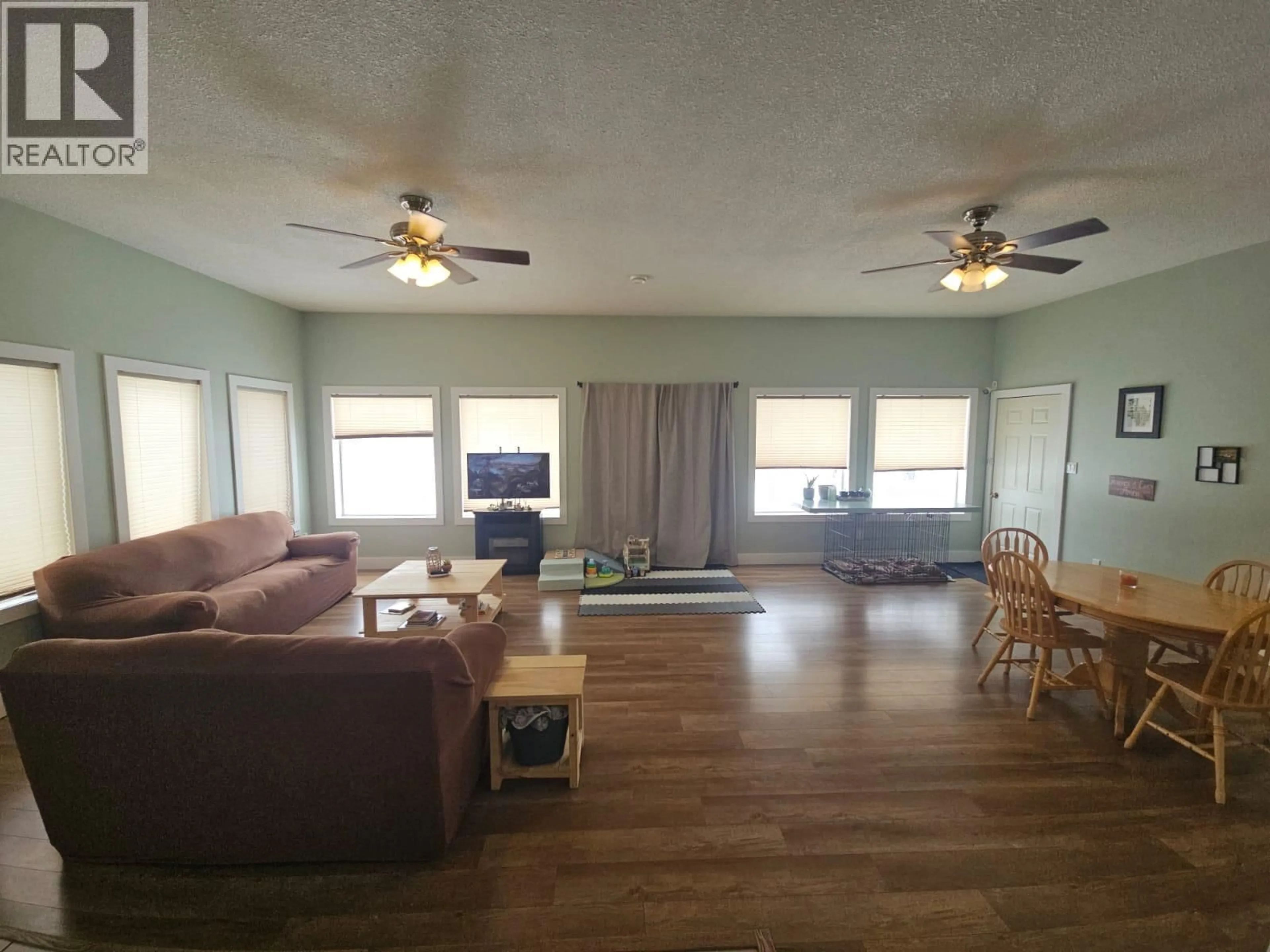 Living room with furniture, wood/laminate floor for 5746 97 HIGHWAY, Dawson Creek British Columbia V1G0J3