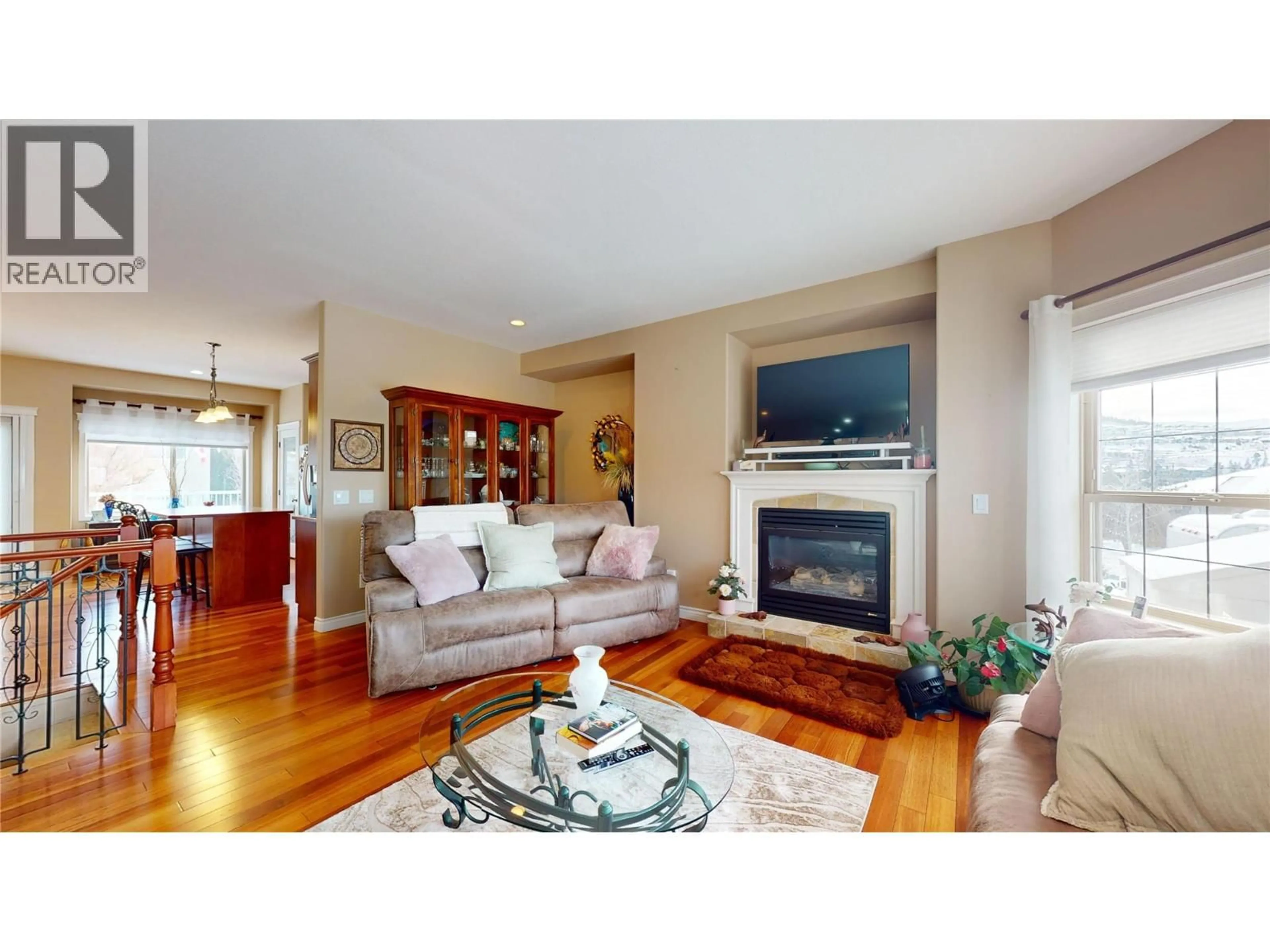 Living room with furniture, wood/laminate floor for 1505 TANEMURA CRESCENT, Kelowna British Columbia V1P1N8