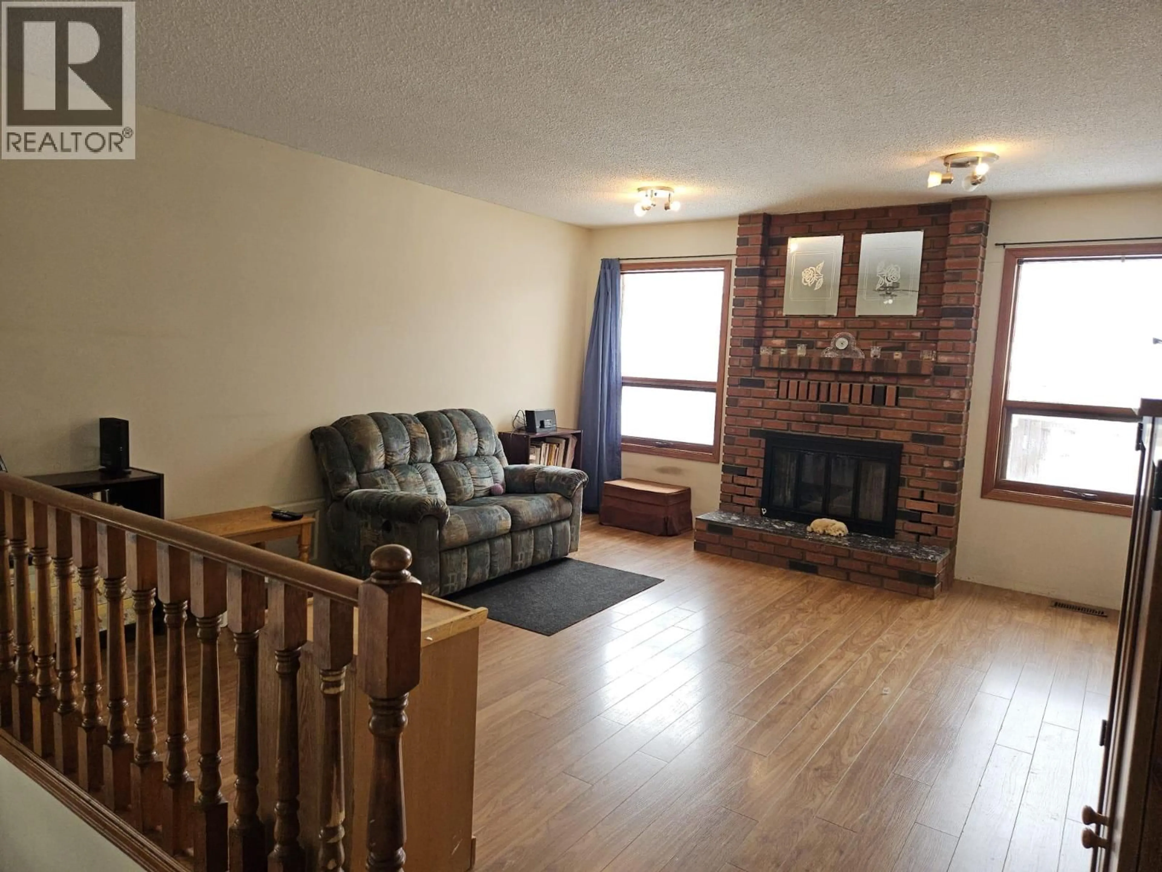 Living room with furniture, wood/laminate floor for 167 SUKUNKA AVENUE, Tumbler Ridge British Columbia V0C2W0