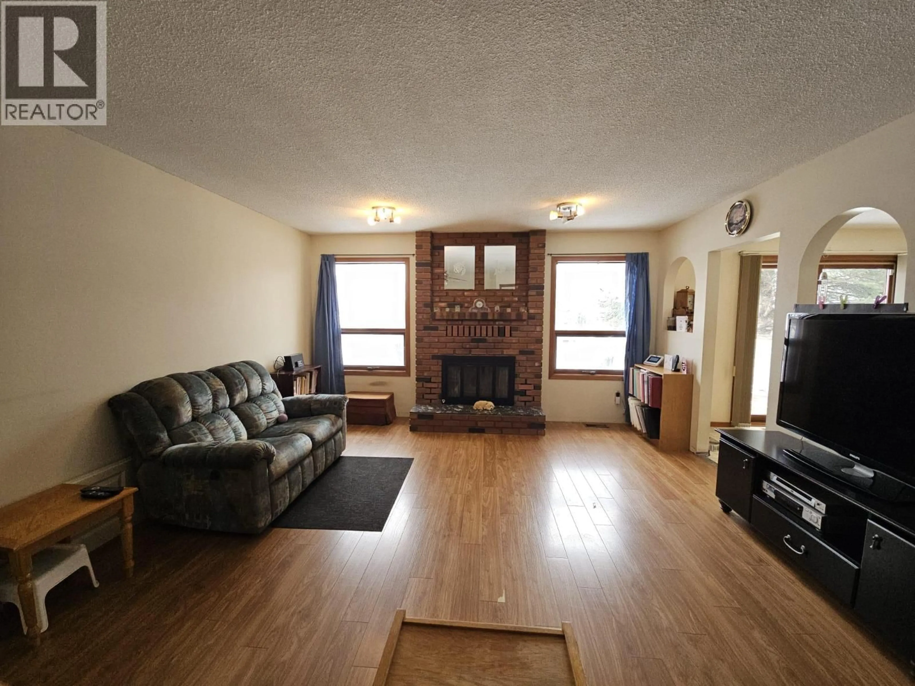 Living room with furniture, wood/laminate floor for 167 SUKUNKA AVENUE, Tumbler Ridge British Columbia V0C2W0