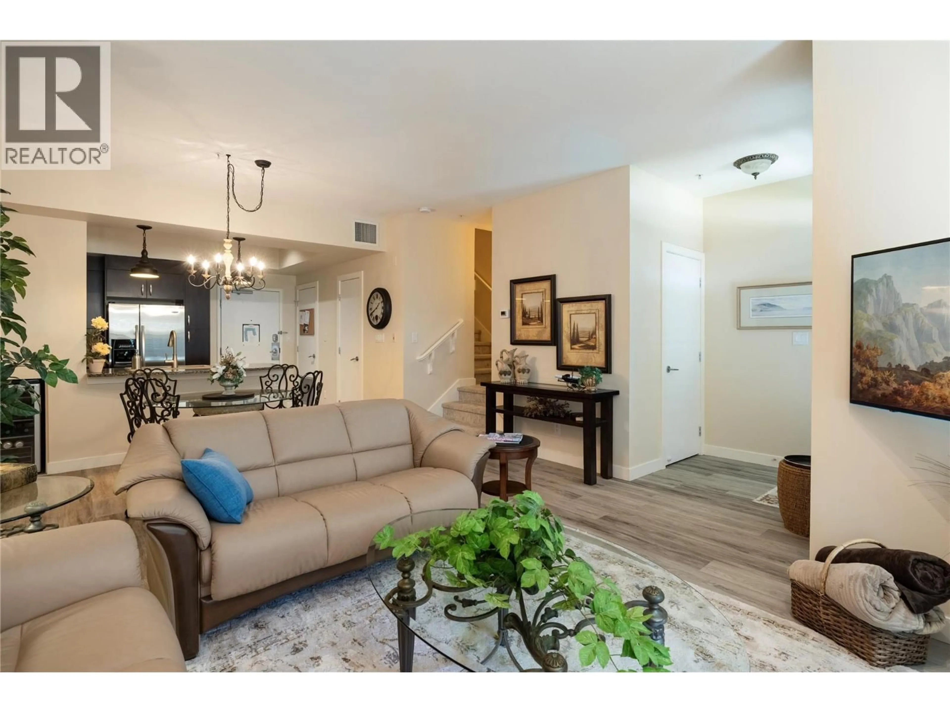 Living room with furniture, wood/laminate floor for 1130 - 7343 OKANAGAN LANDING ROAD, Vernon British Columbia V1H2J6