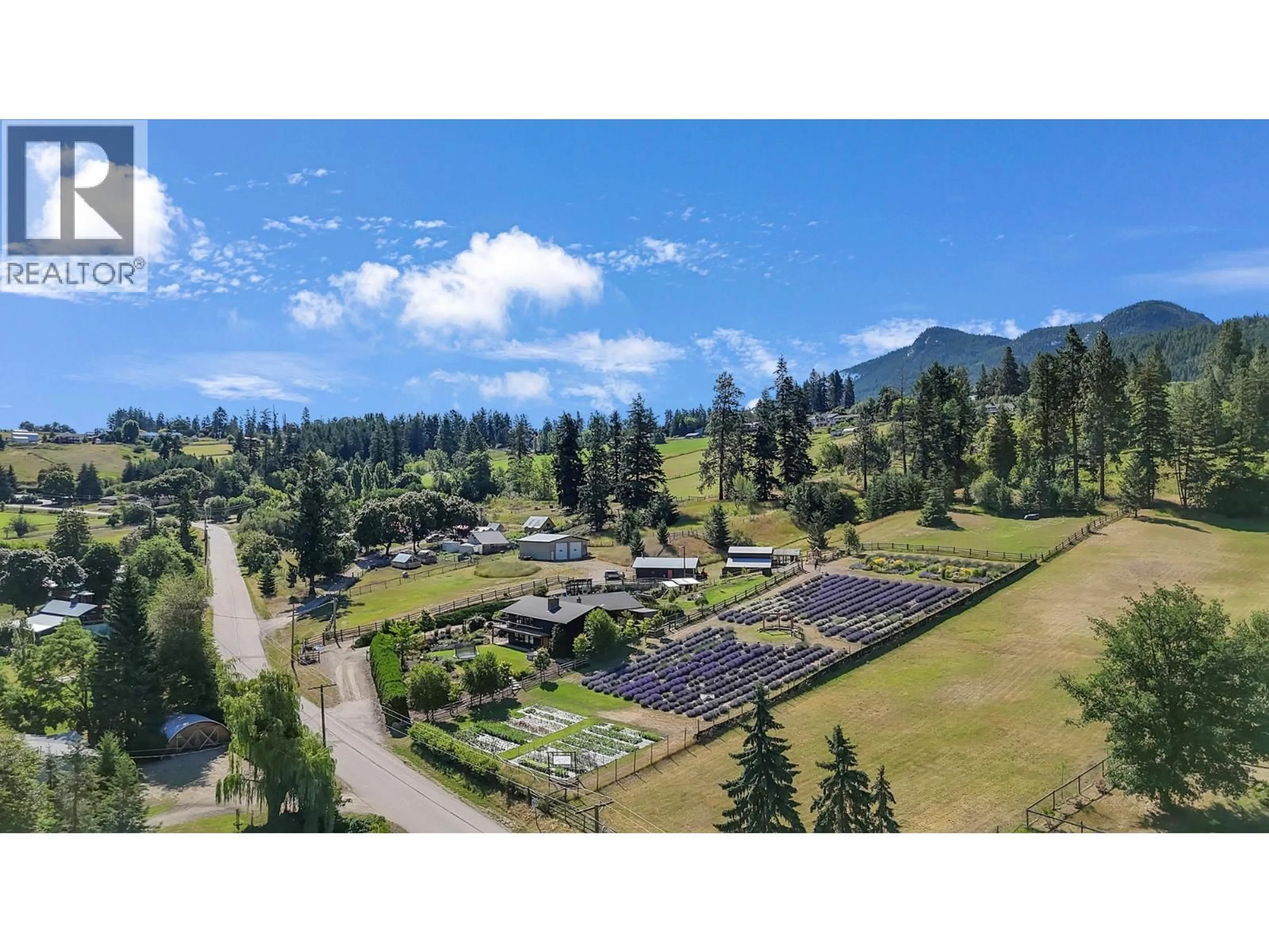 A pic from outside/outdoor area/front of a property/back of a property/a pic from drone, mountain view for 5770 LEARMOUTH ROAD, Coldstream British Columbia V1B3E6