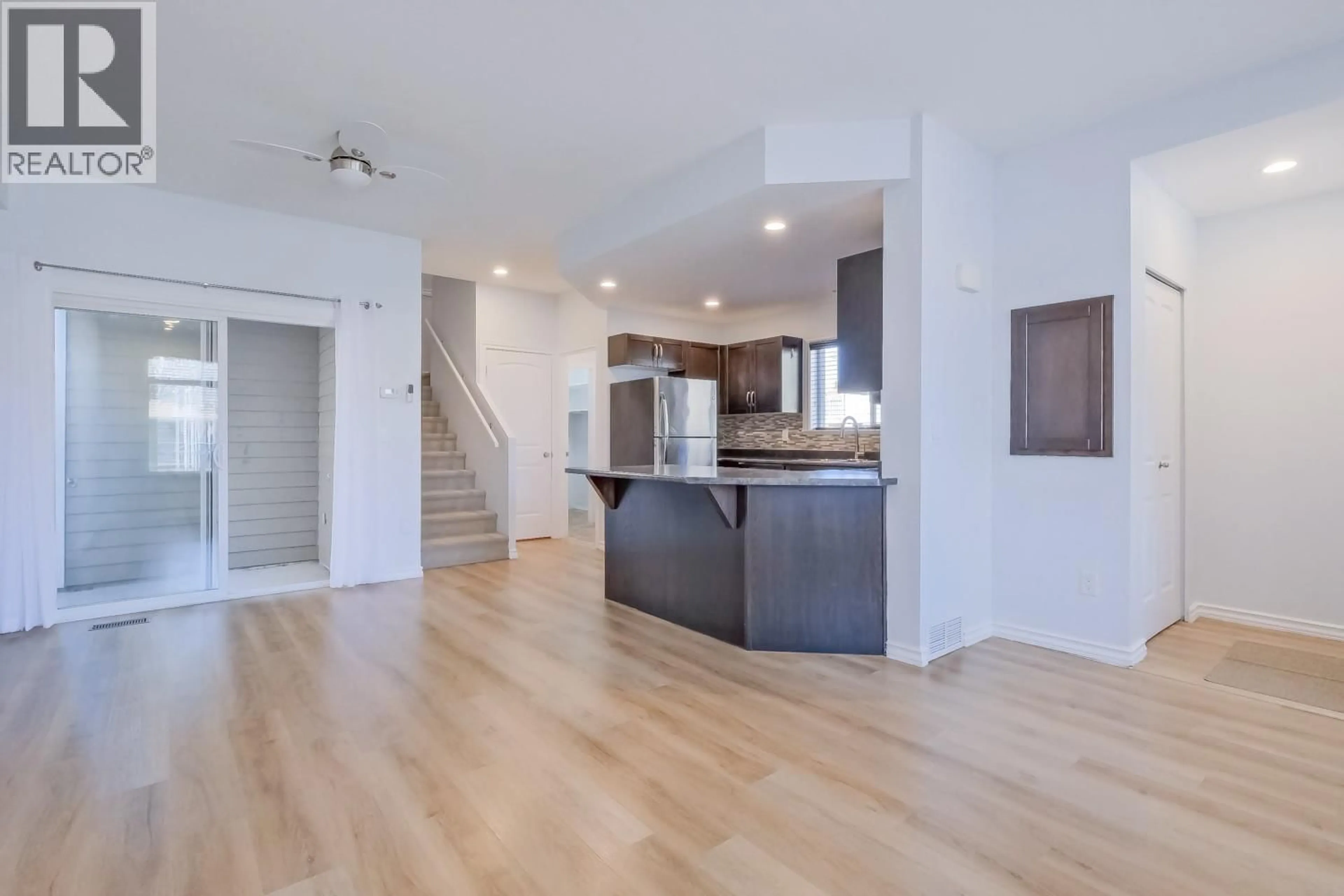 Open concept kitchen, wood/laminate floor for 101 - 423 TENNIS STREET, Penticton British Columbia V2A5R4