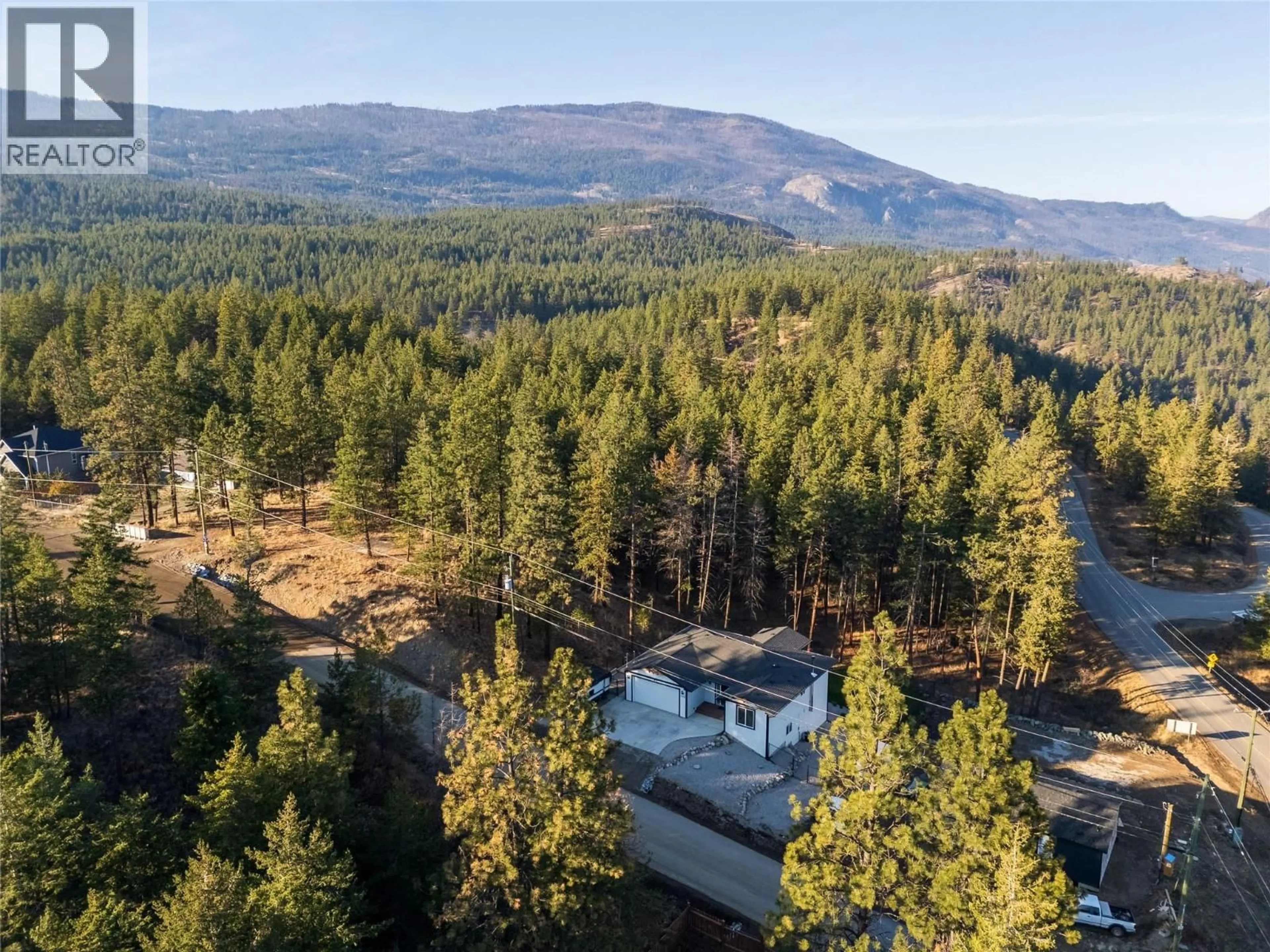 A pic from outside/outdoor area/front of a property/back of a property/a pic from drone, forest/trees view for 530 MUIR ROAD, Fintry British Columbia V1Z3W1