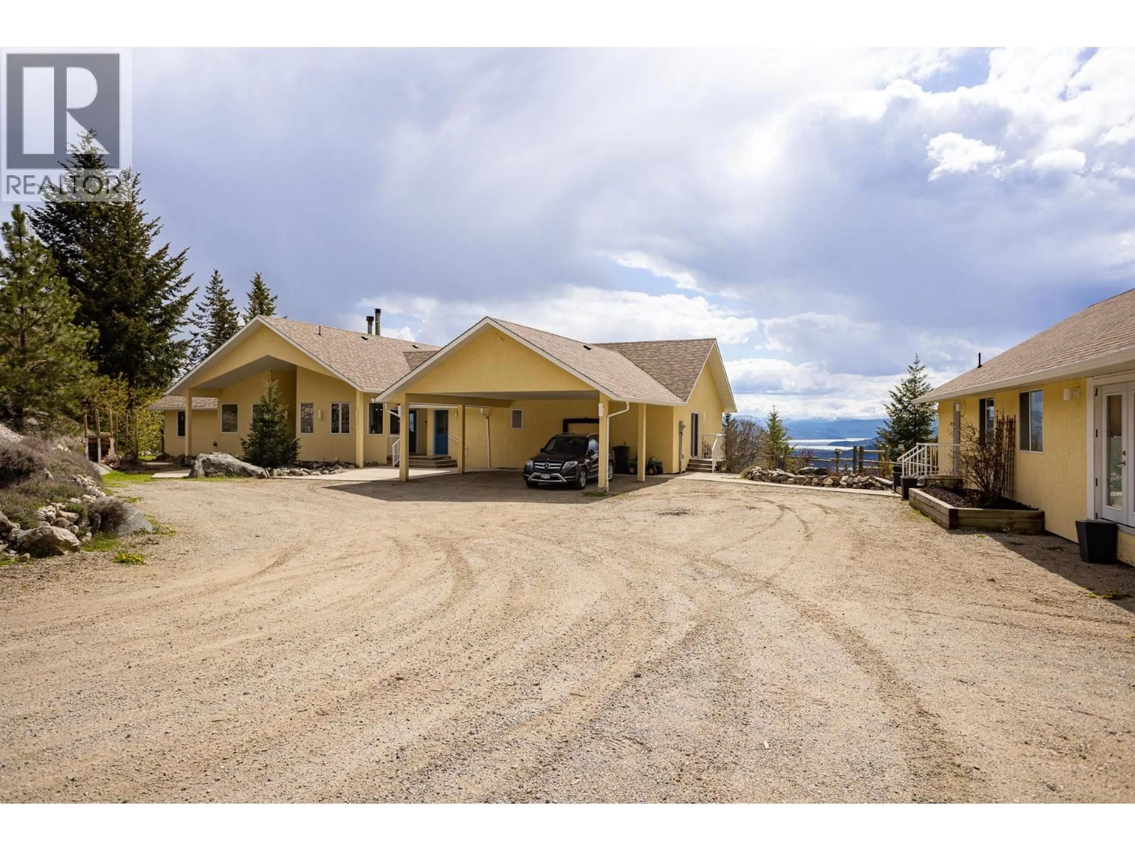 A pic from outside/outdoor area/front of a property/back of a property/a pic from drone, mountain view for 6720 LANGLEY COURT, Kelowna British Columbia V1P1A4