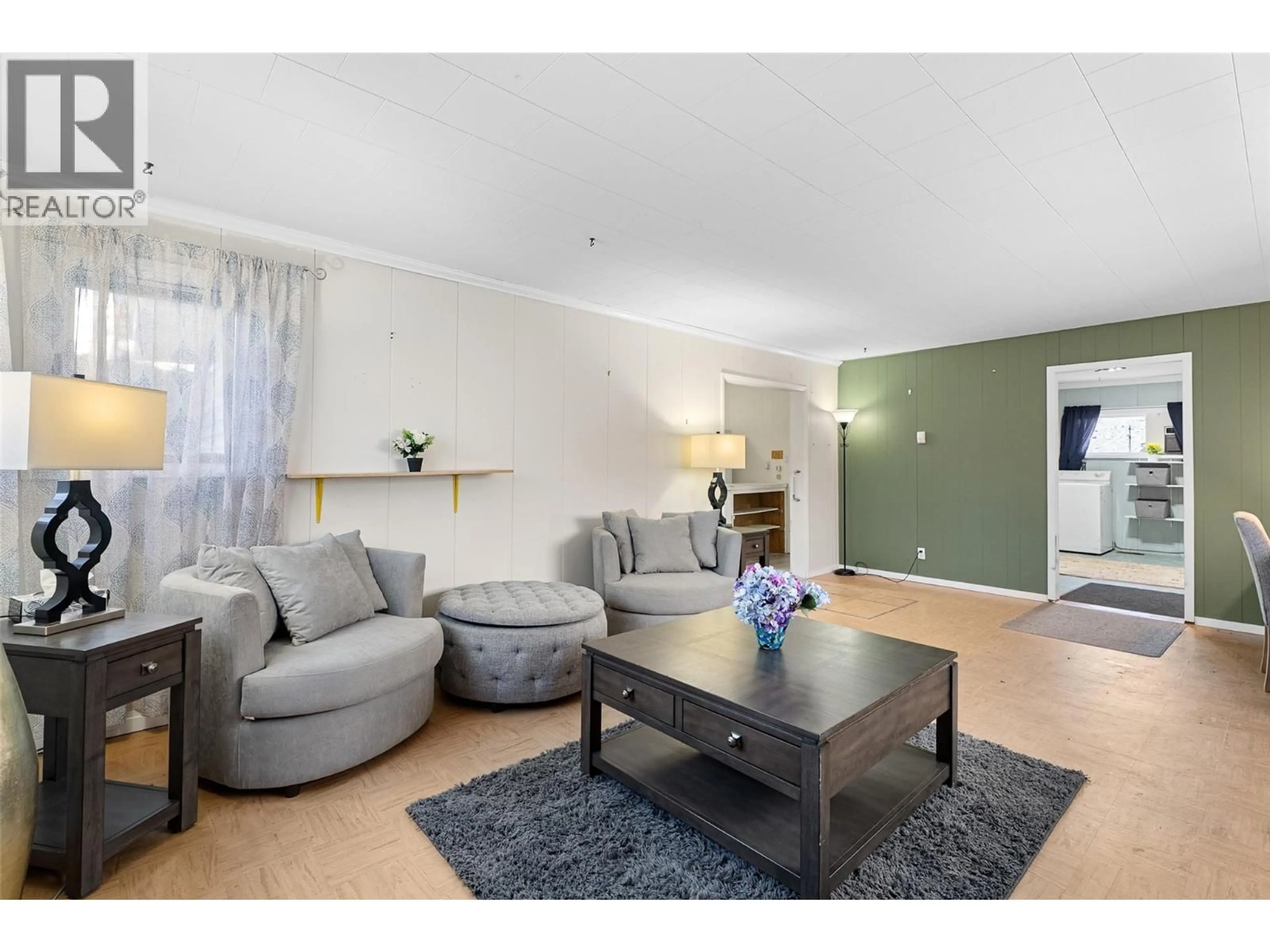 Living room with furniture, wood/laminate floor for 2498 CHAPMAN STREET, Merritt British Columbia V1K1J7
