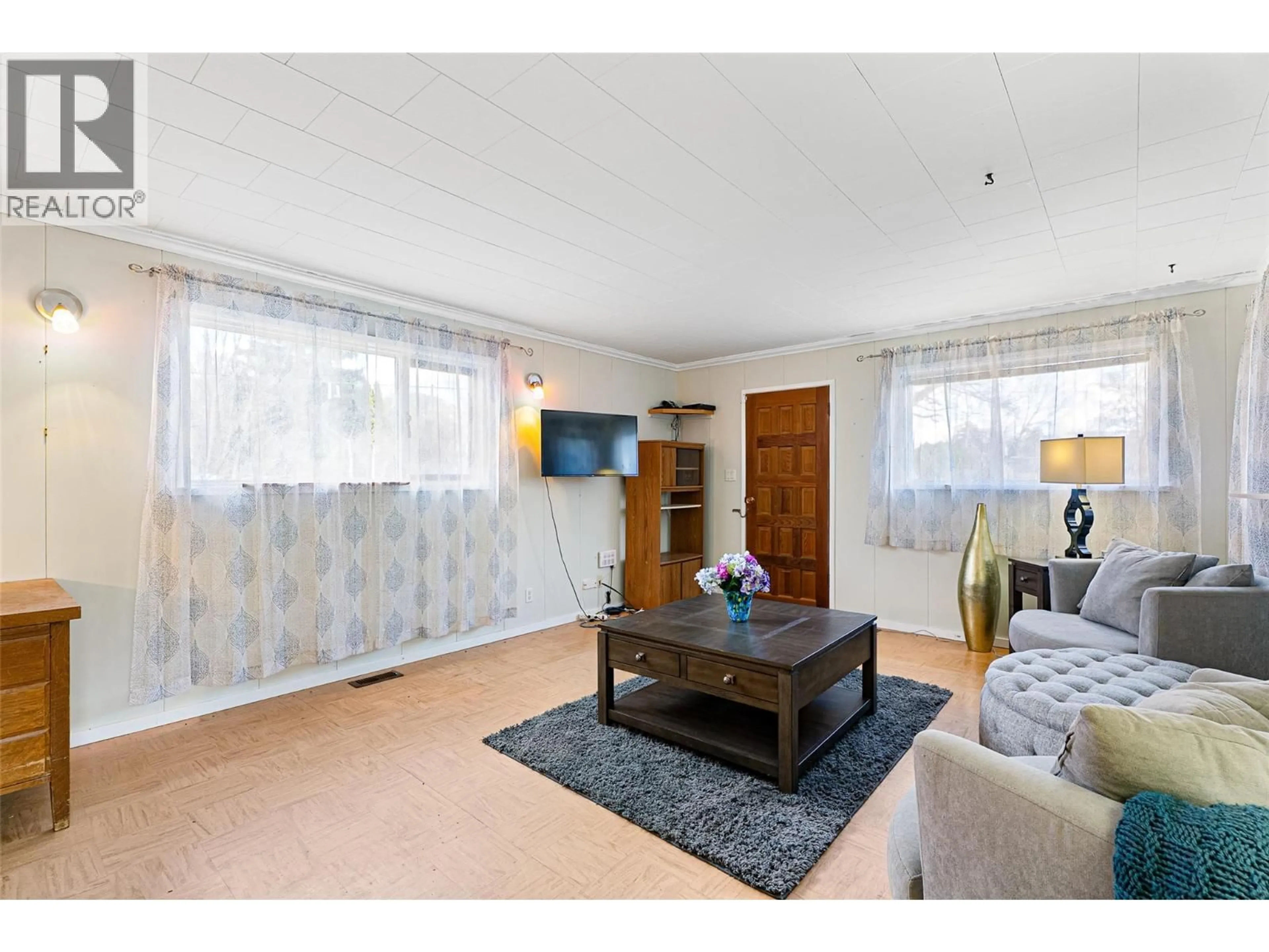 Living room with furniture, wood/laminate floor for 2498 CHAPMAN STREET, Merritt British Columbia V1K1J7