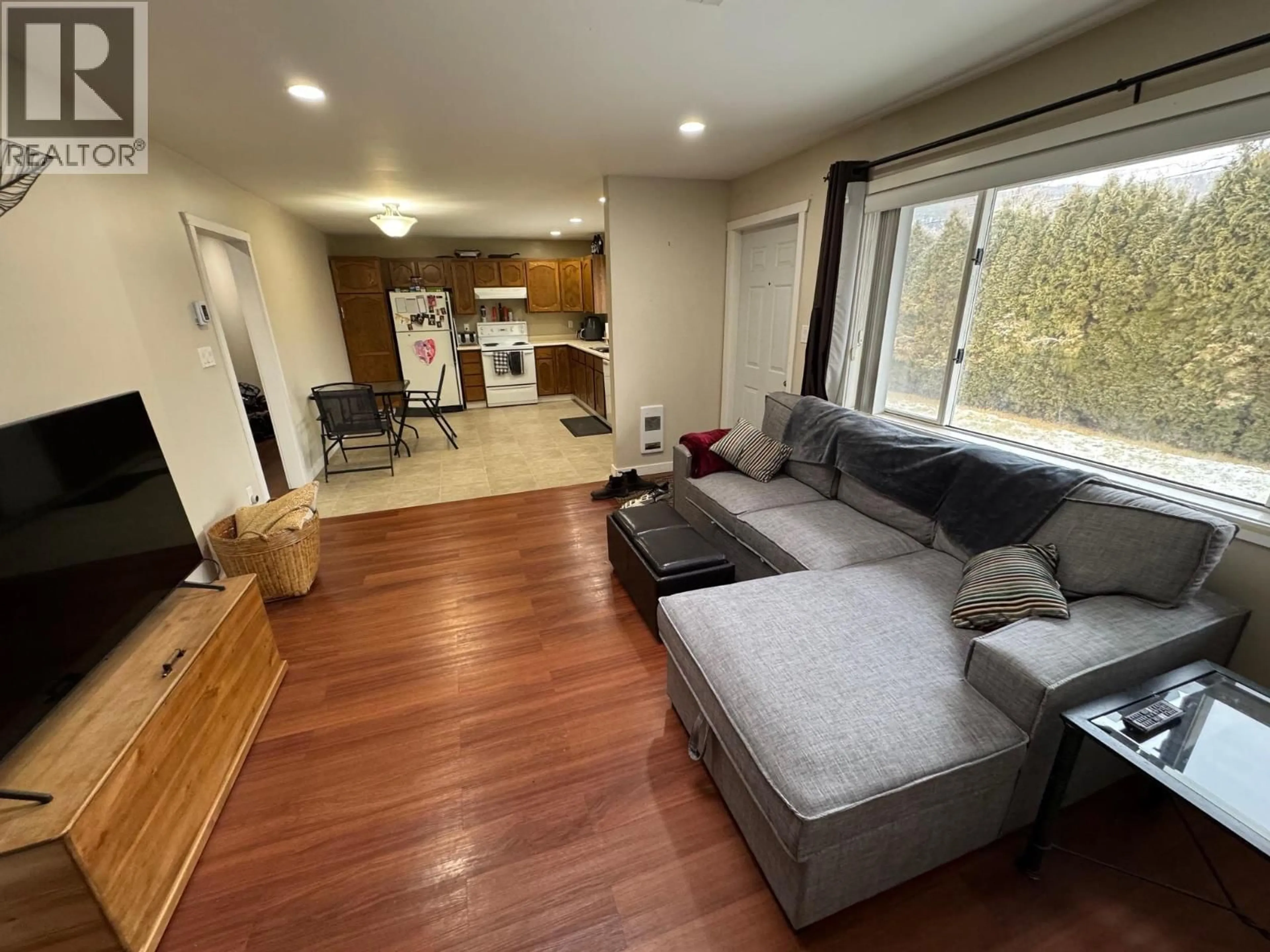 Living room with furniture, wood/laminate floor for 2540 COUTLEE AVENUE, Merritt British Columbia V1K1B8