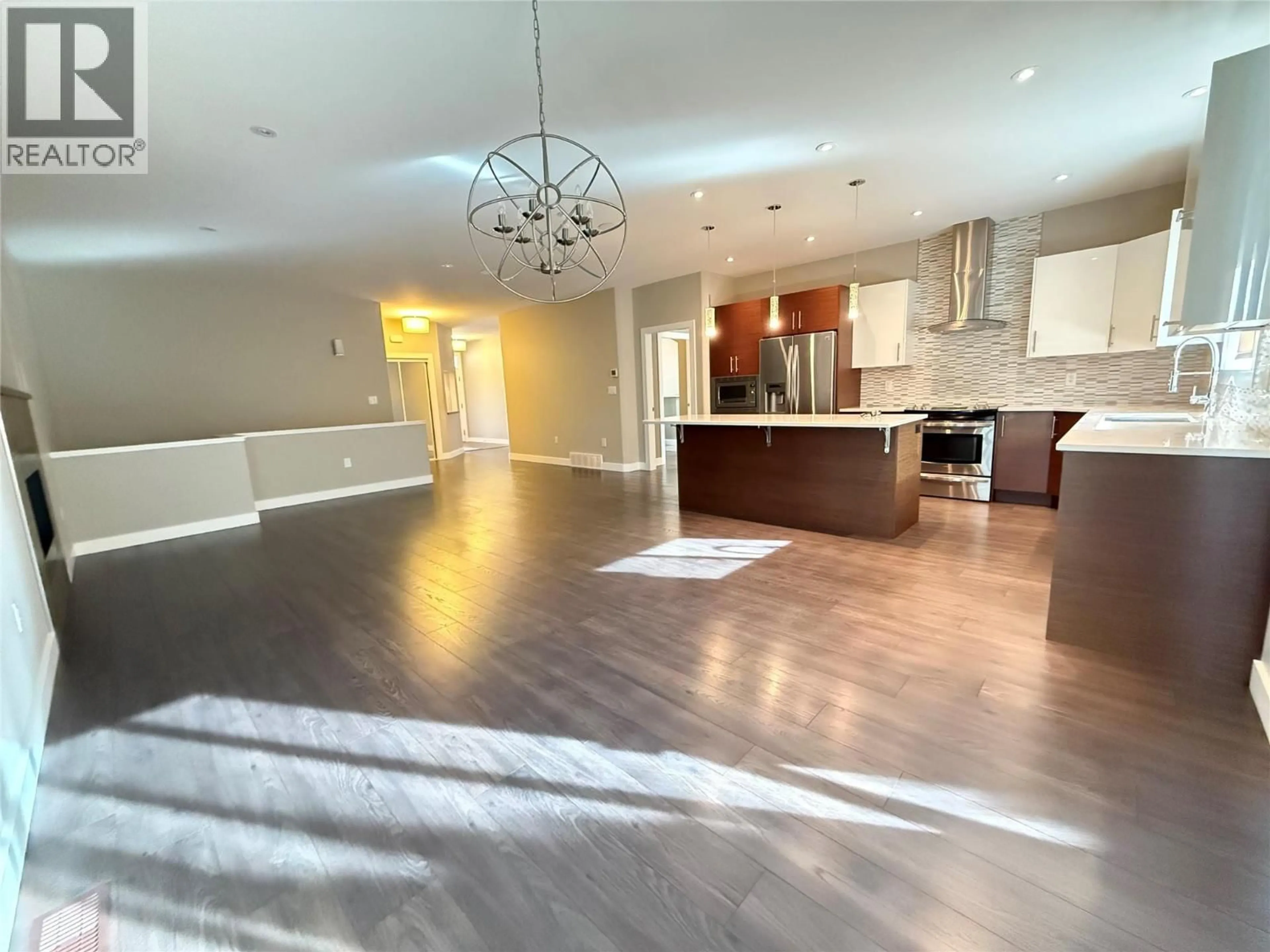 Open concept kitchen, wood/laminate floor for 169 - 170 STOCKS CRESCENT, Penticton British Columbia V2A9C6