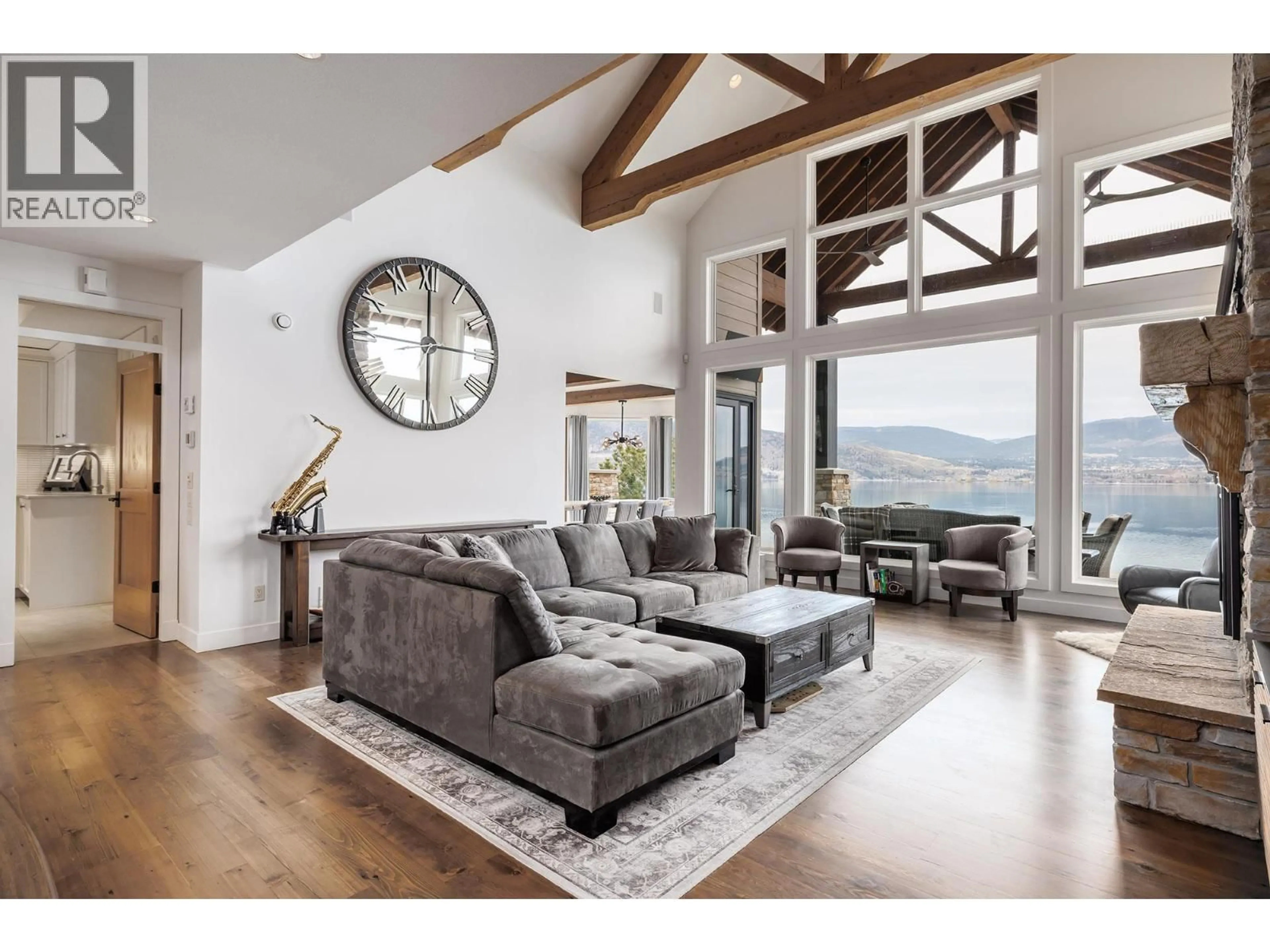 Living room with furniture, wood/laminate floor for 6850 LAKESHORE ROAD, Kelowna British Columbia V1W4J5