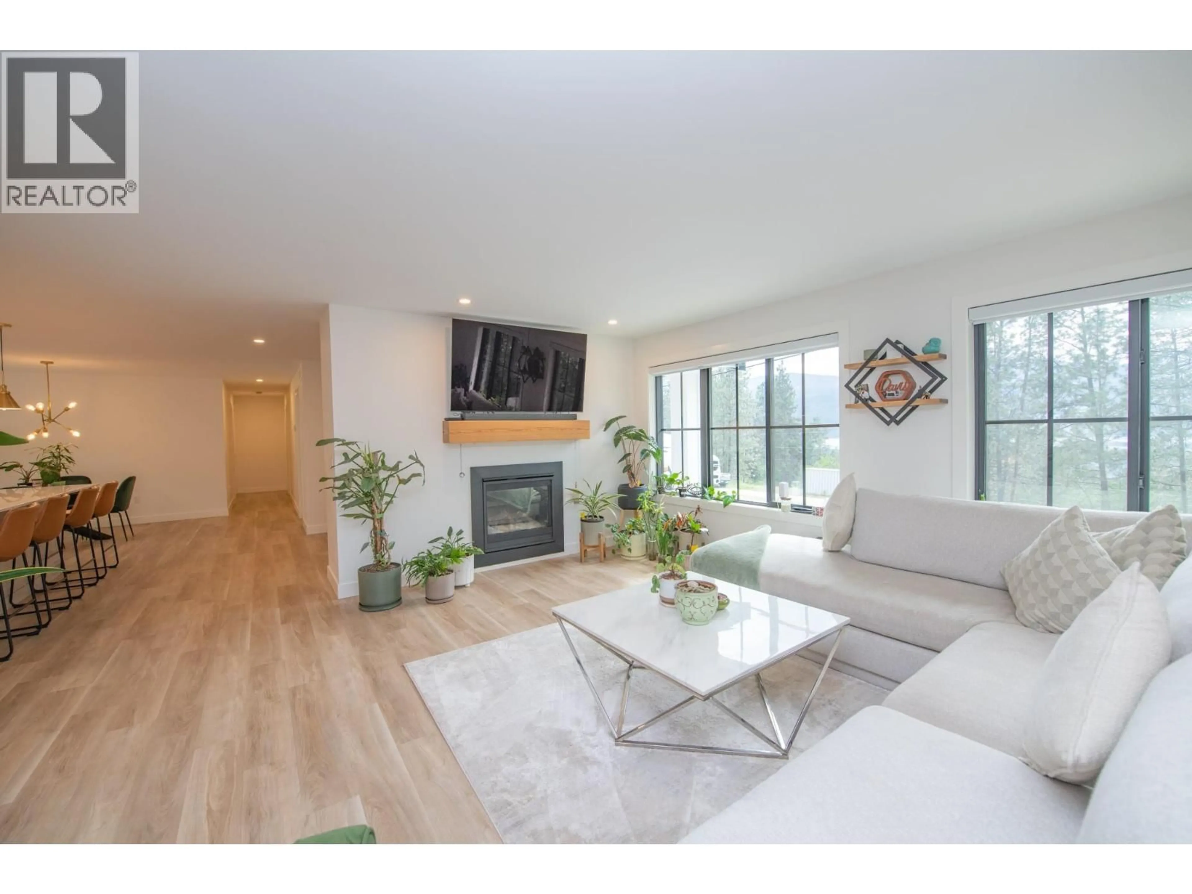 Living room with furniture, wood/laminate floor for 16515 COMMONAGE ROAD, Lake Country British Columbia V4V1B3