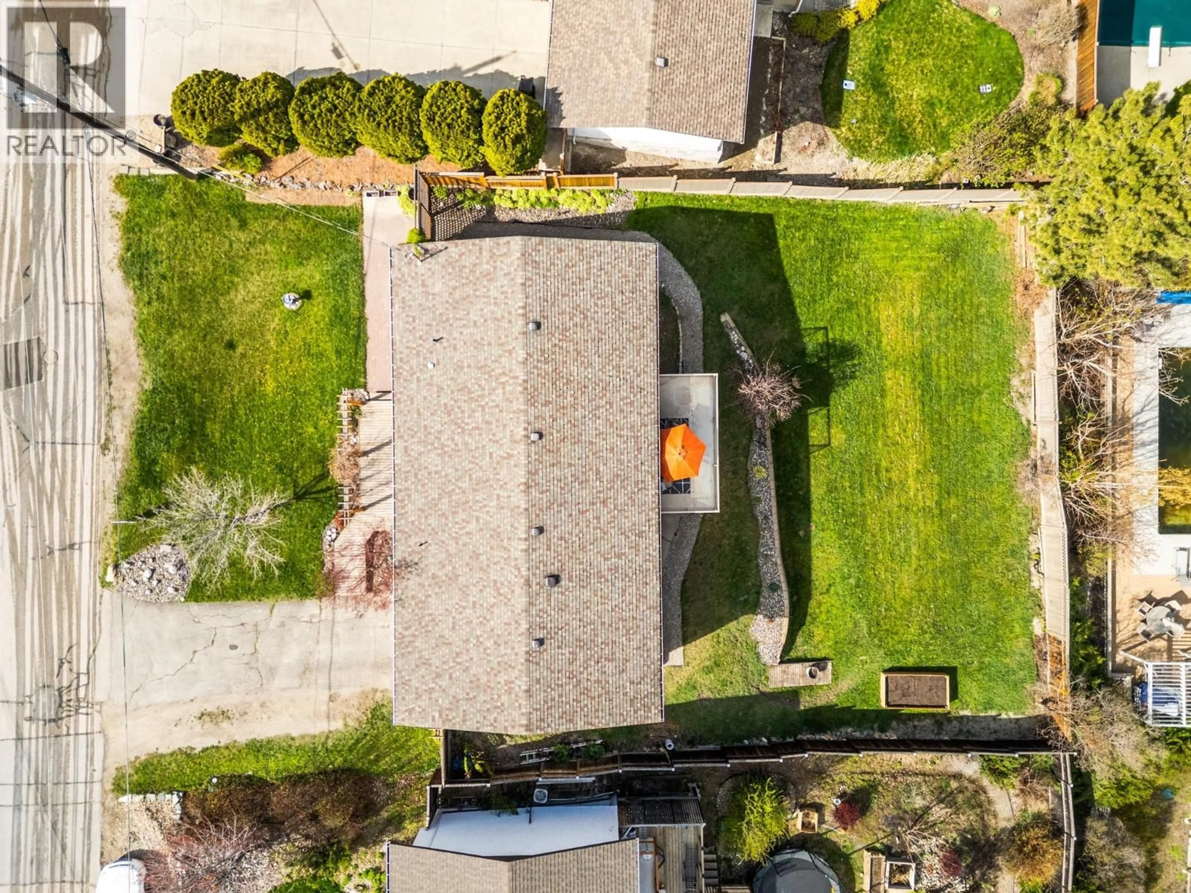 A pic from outside/outdoor area/front of a property/back of a property/a pic from drone, street for 7339 LONGACRE DRIVE, Vernon British Columbia V1H1H5