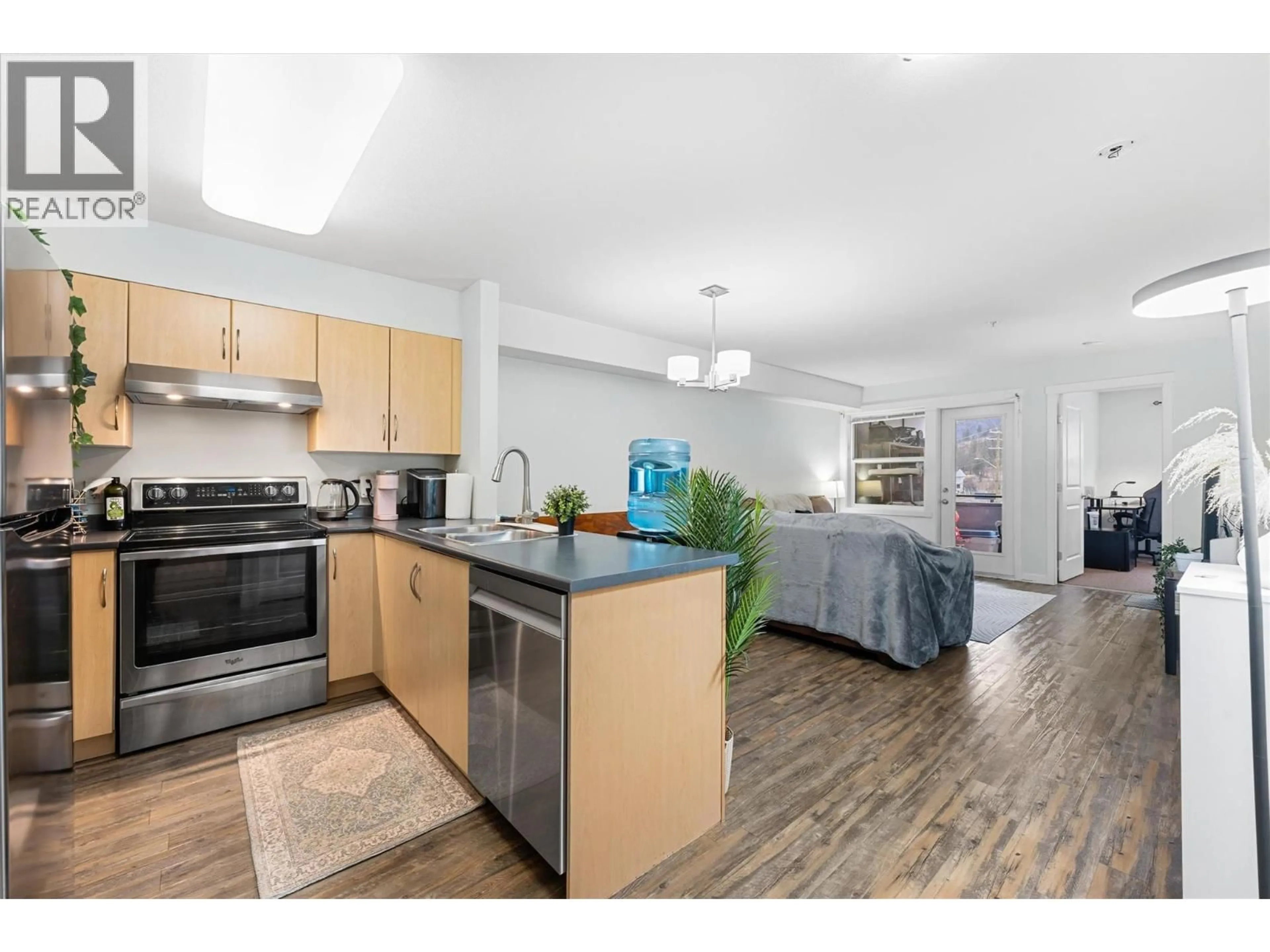 Open concept kitchen, wood/laminate floor for 206 - 1479 GLENMORE ROAD NORTH, Kelowna British Columbia V1V2C5