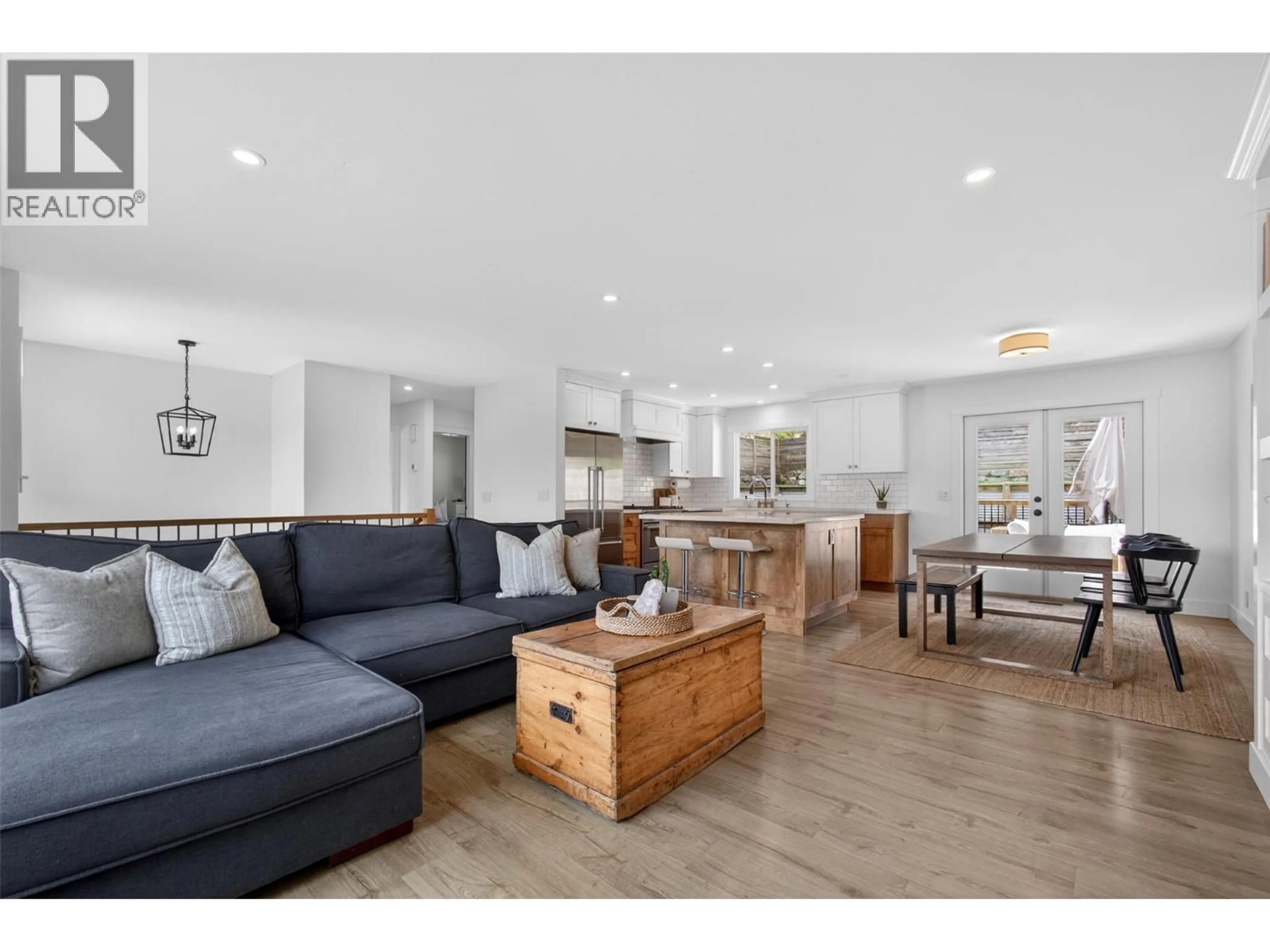 Living room with furniture, wood/laminate floor for 9742 OKANAGAN CENTRE ROAD EAST, Lake Country British Columbia V4V1T6