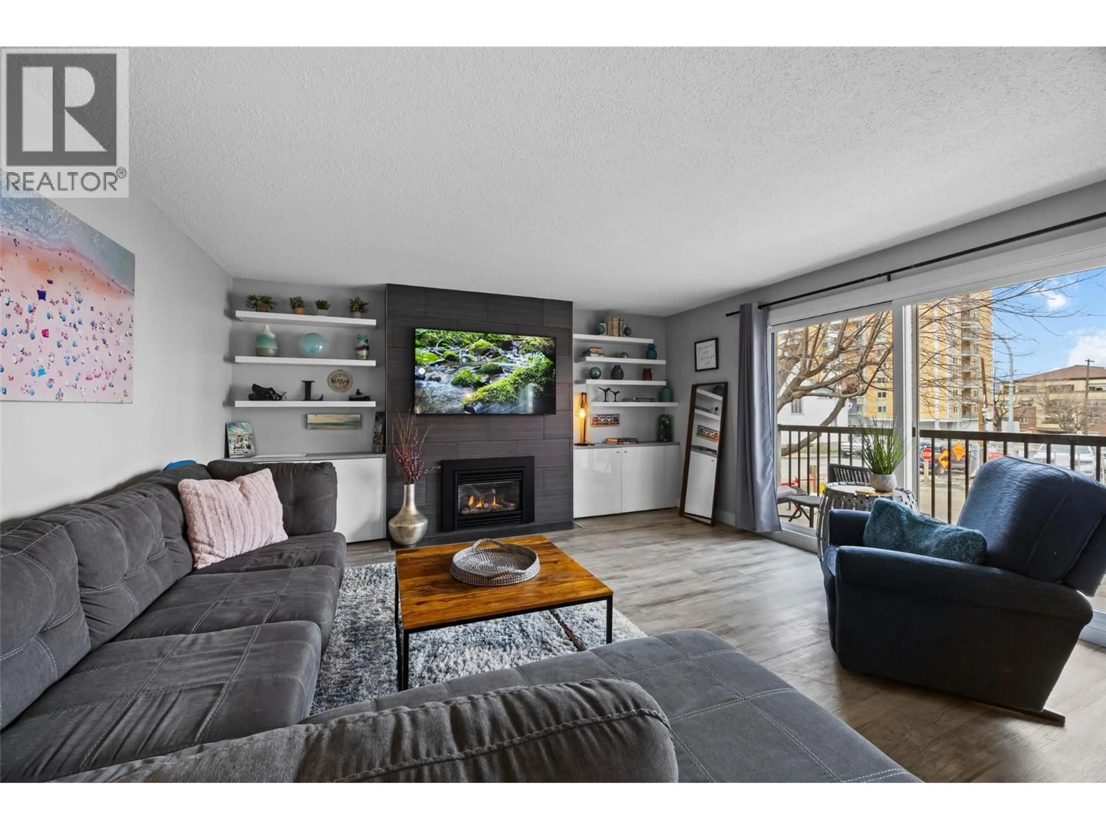 Living room with furniture, wood/laminate floor for 102 - 411 NICOLA STREET, Kamloops British Columbia V2C2P7