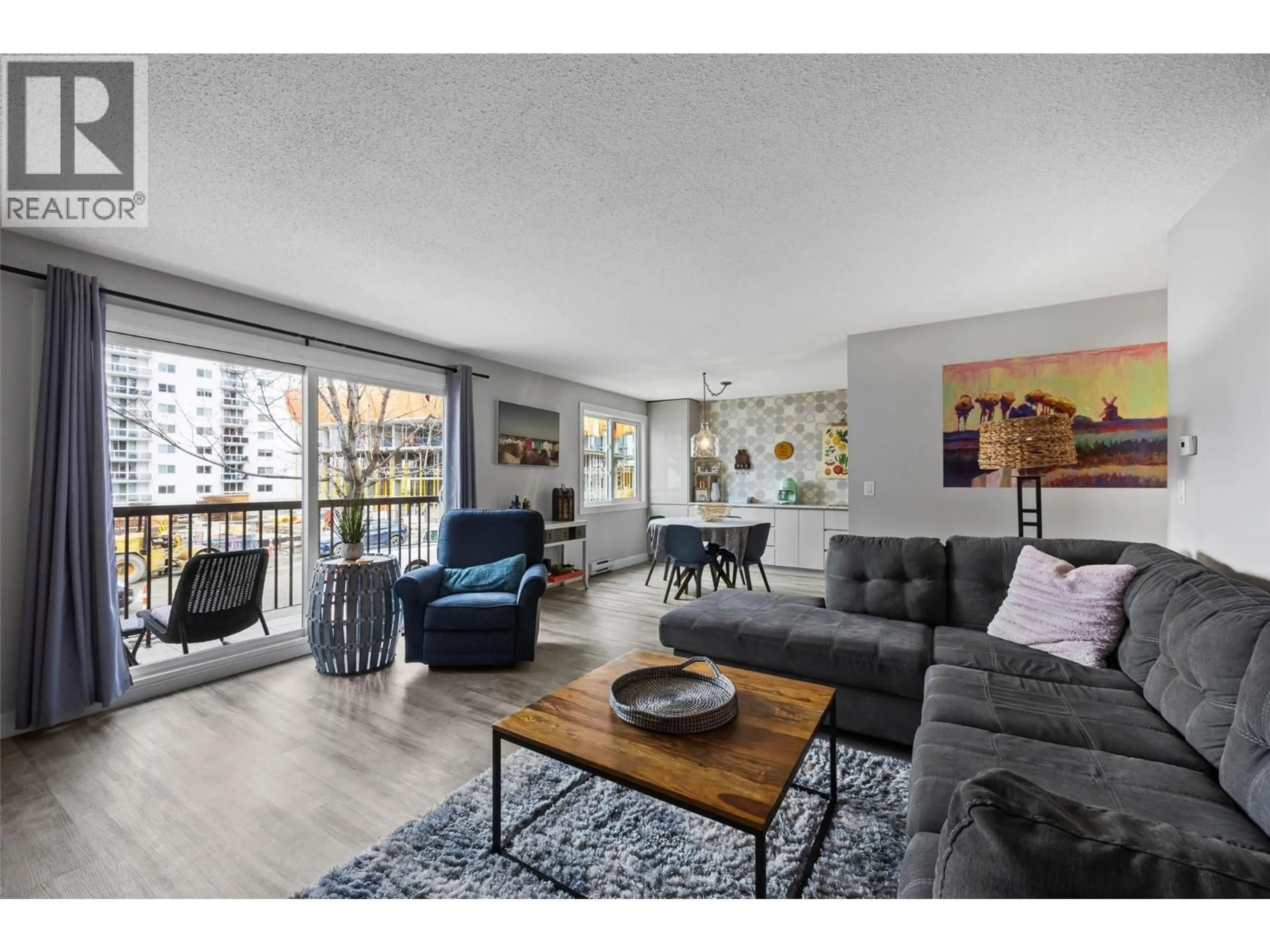 Living room with furniture, wood/laminate floor for 102 - 411 NICOLA STREET, Kamloops British Columbia V2C2P7