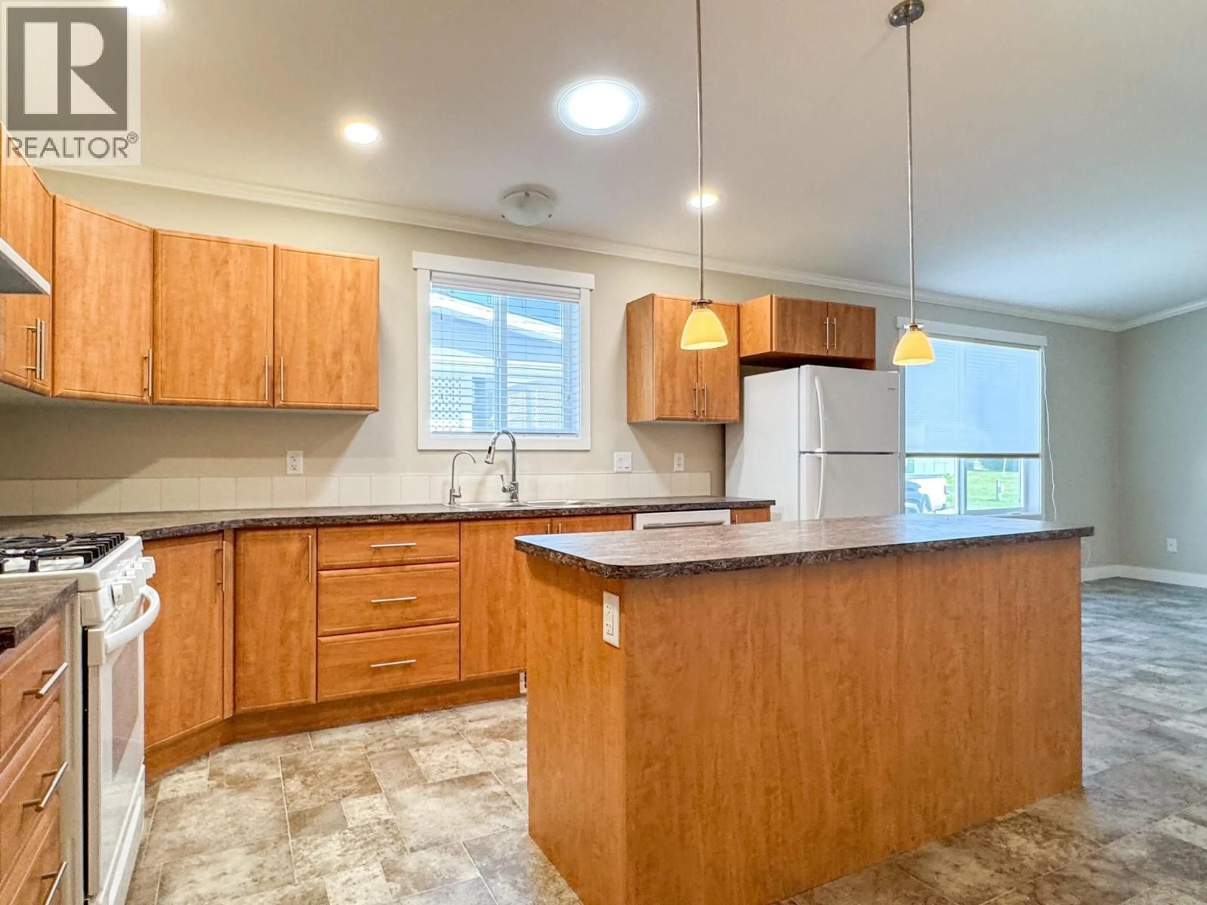 Open concept kitchen, wood/laminate floor for 110B - 3591 OLD VERNON ROAD, Kelowna British Columbia V1X6P4