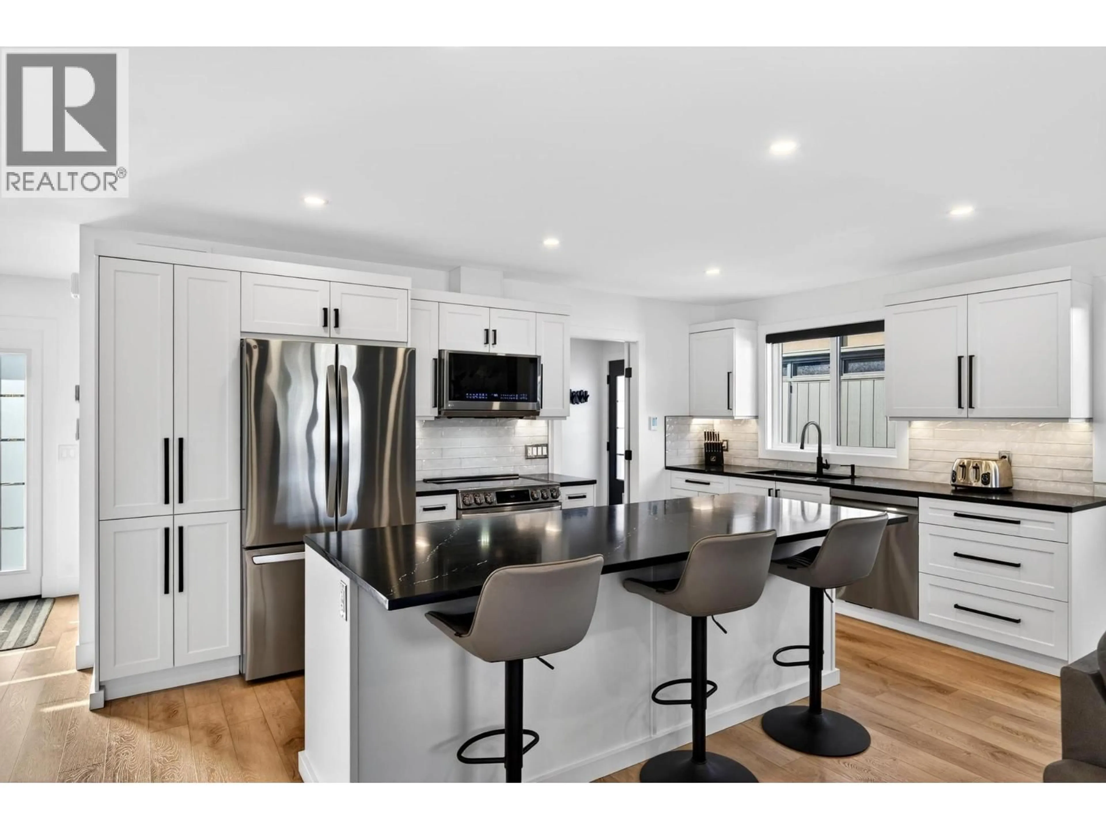 Open concept kitchen, wood/laminate floor for 1674 PRITCHARD DRIVE, West Kelowna British Columbia V4T1X5