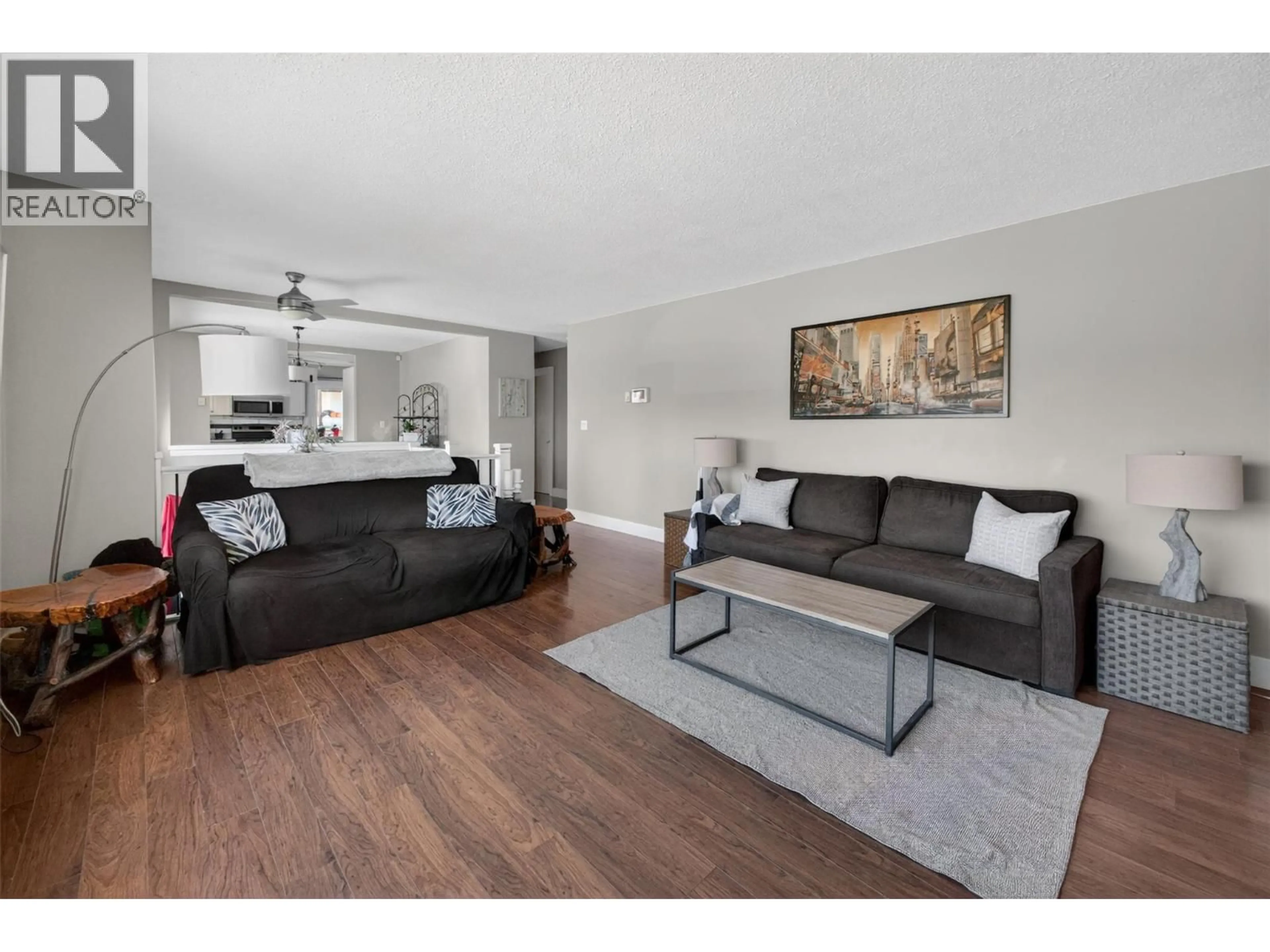 Living room with furniture, wood/laminate floor for 2126 VERDE VISTA ROAD, Kelowna British Columbia V1P1G5