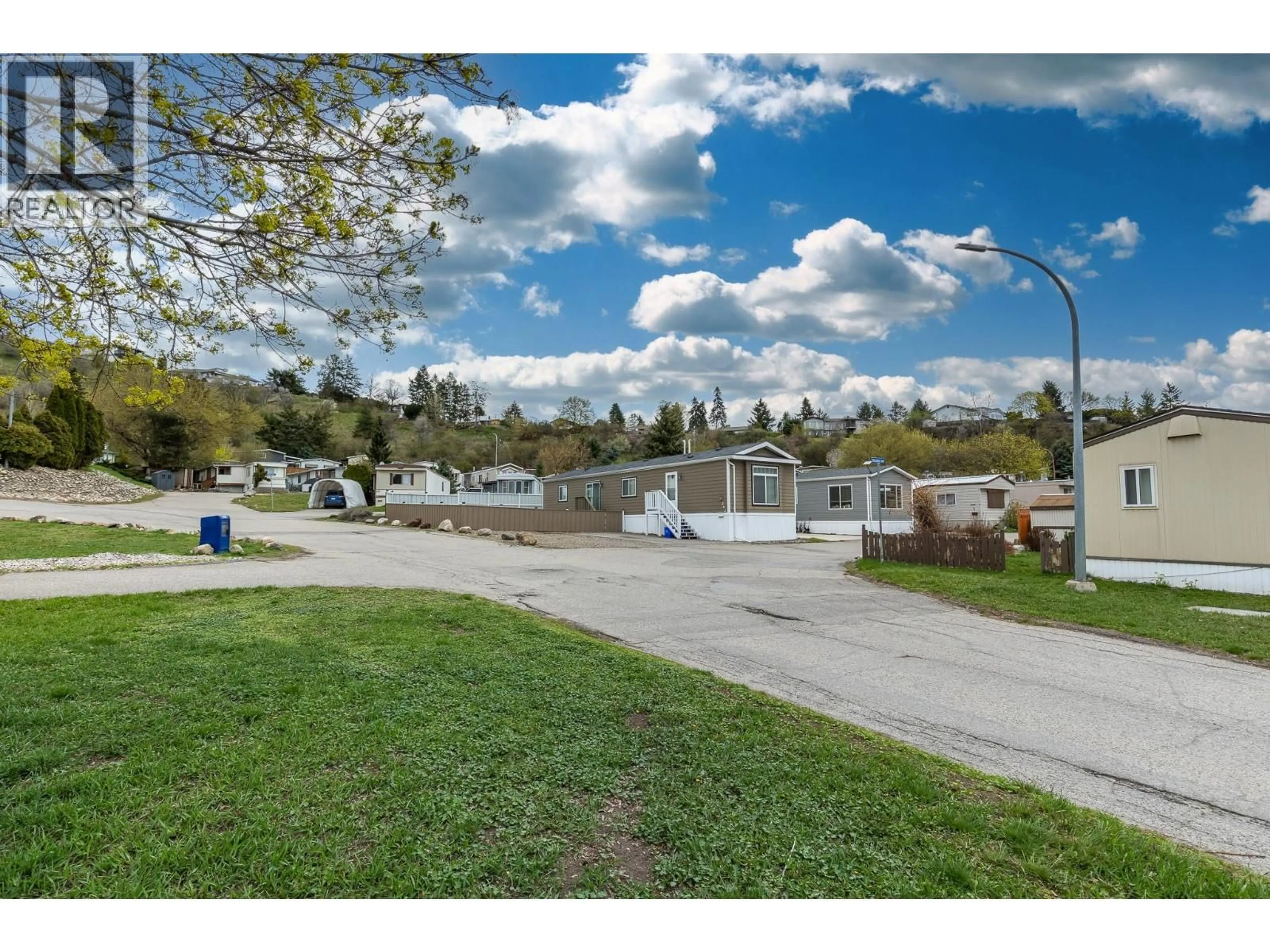 A pic from outside/outdoor area/front of a property/back of a property/a pic from drone, street for 202 - 15401 KALAMALKA ROAD, Coldstream British Columbia V1B1Z3