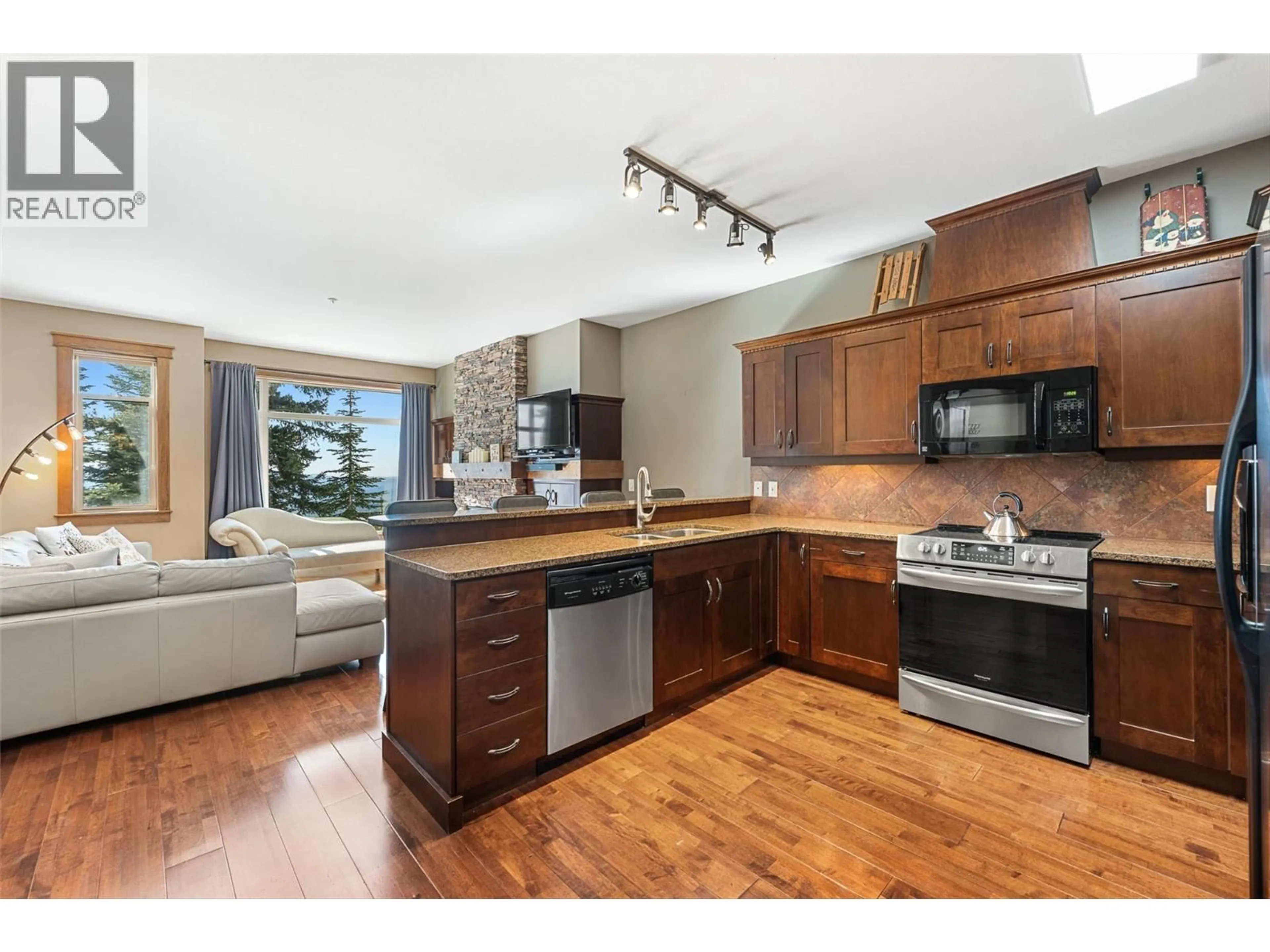 Open concept kitchen, wood/laminate floor for 2 - 5895 SNOW PINES WAY, Big White British Columbia V1P1T4