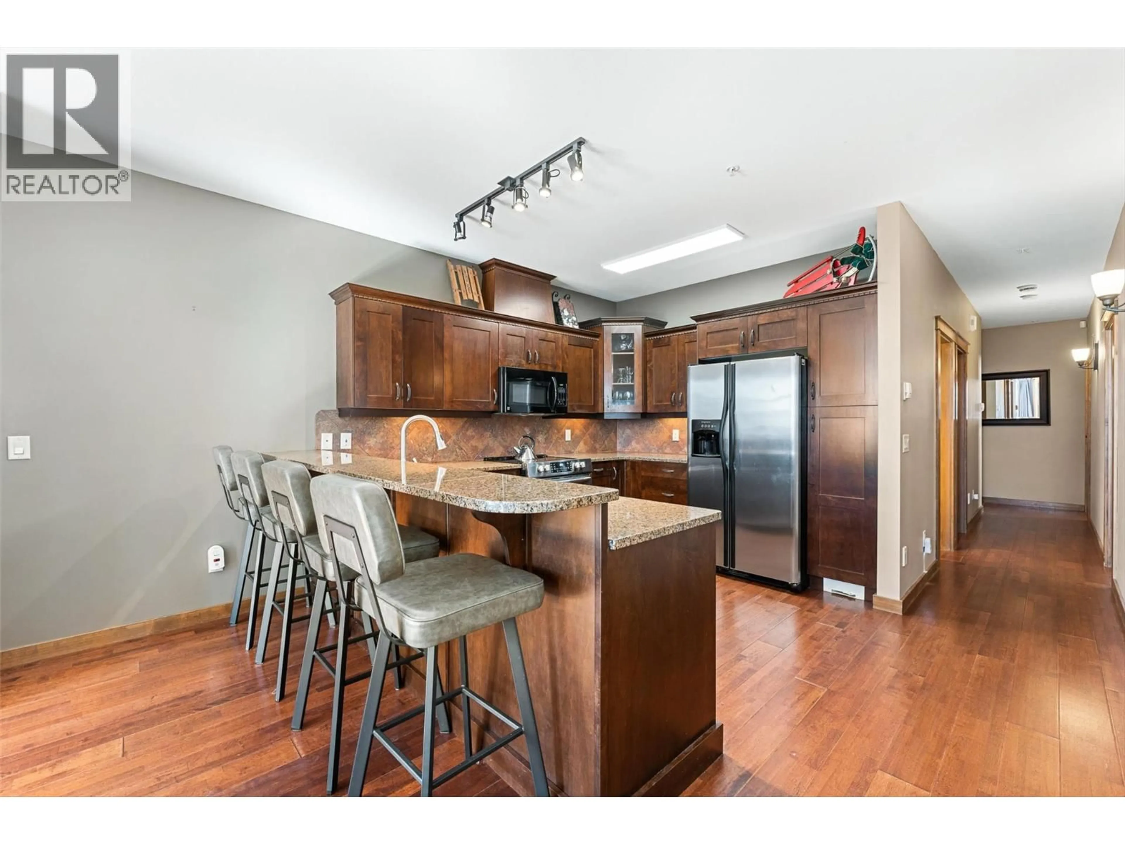 Open concept kitchen, wood/laminate floor for 2 - 5895 SNOW PINES WAY, Big White British Columbia V1P1T4