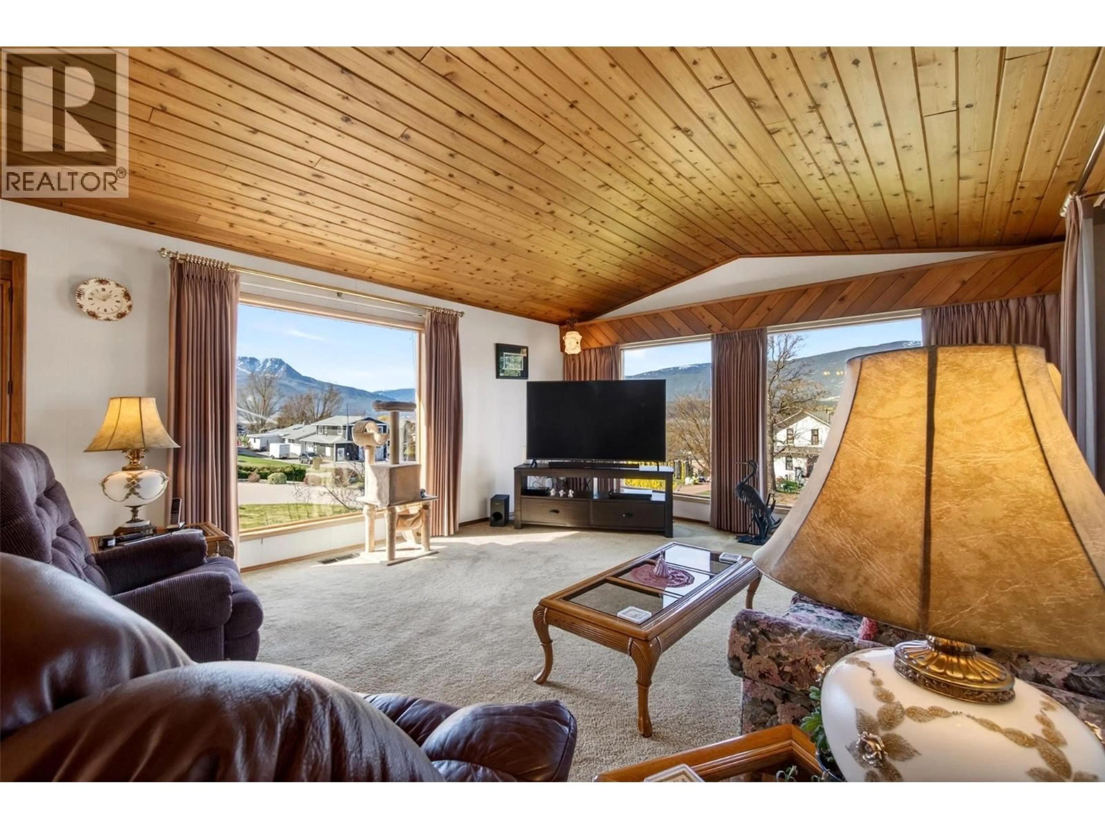 Living room with furniture, wood/laminate floor for 4860 14 STREET NORTHEAST, Salmon Arm British Columbia V1E3P2