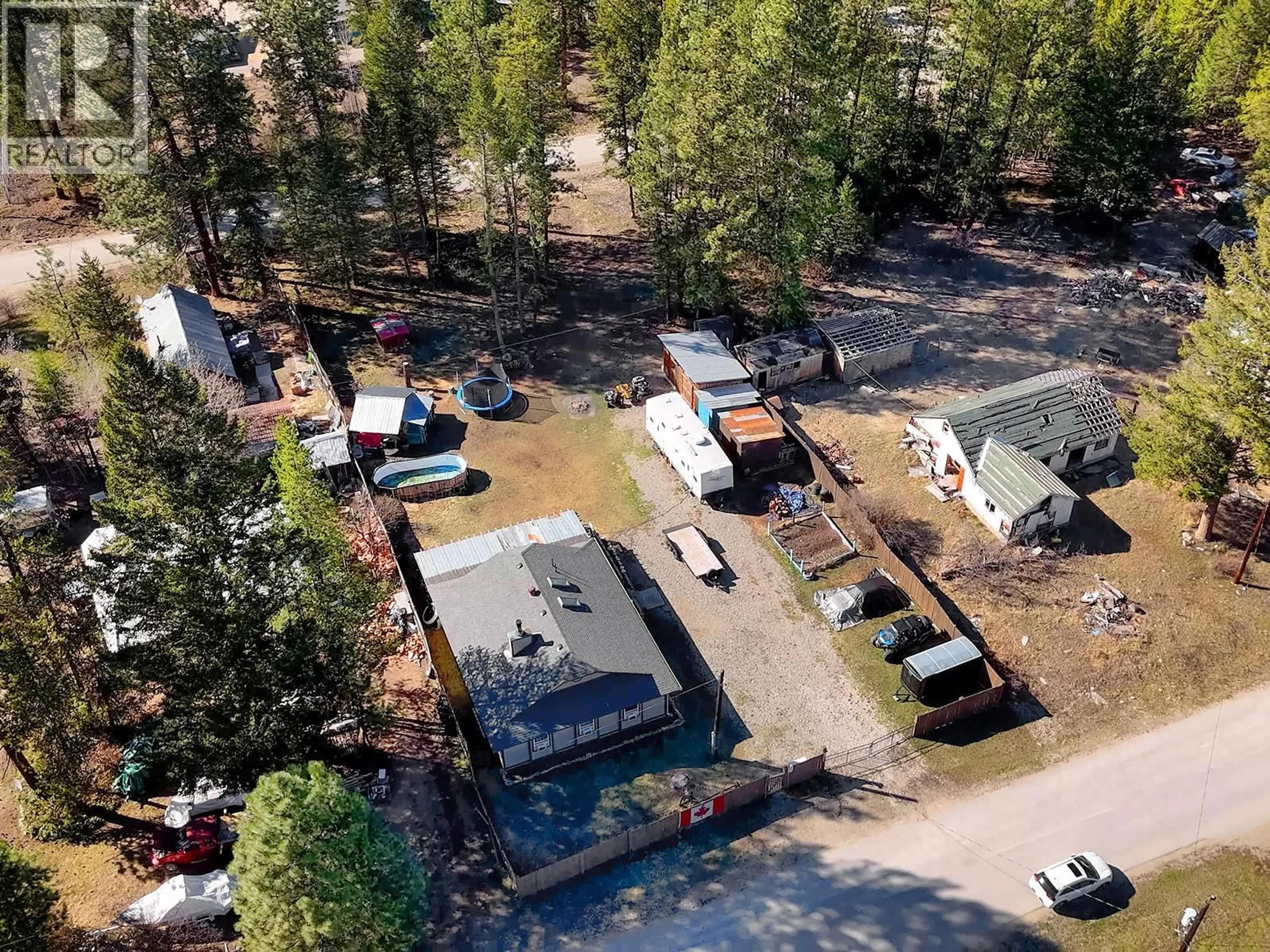 A pic from outside/outdoor area/front of a property/back of a property/a pic from drone, forest/trees view for 5835 3RD STREET, Beaverdell British Columbia V0H1A0
