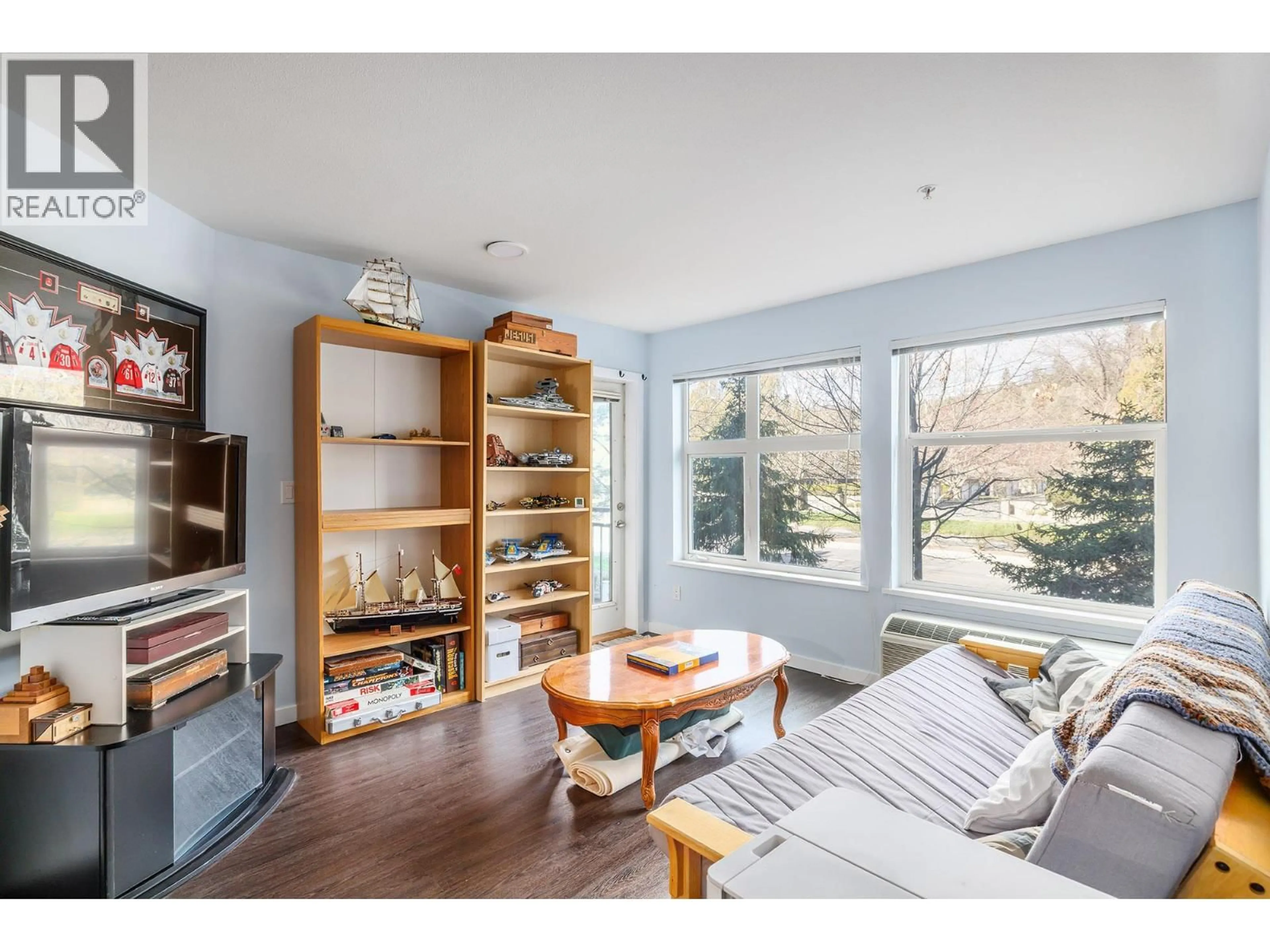 Living room with furniture, wood/laminate floor for 206 - 555 YATES ROAD, Kelowna British Columbia V1V2V2