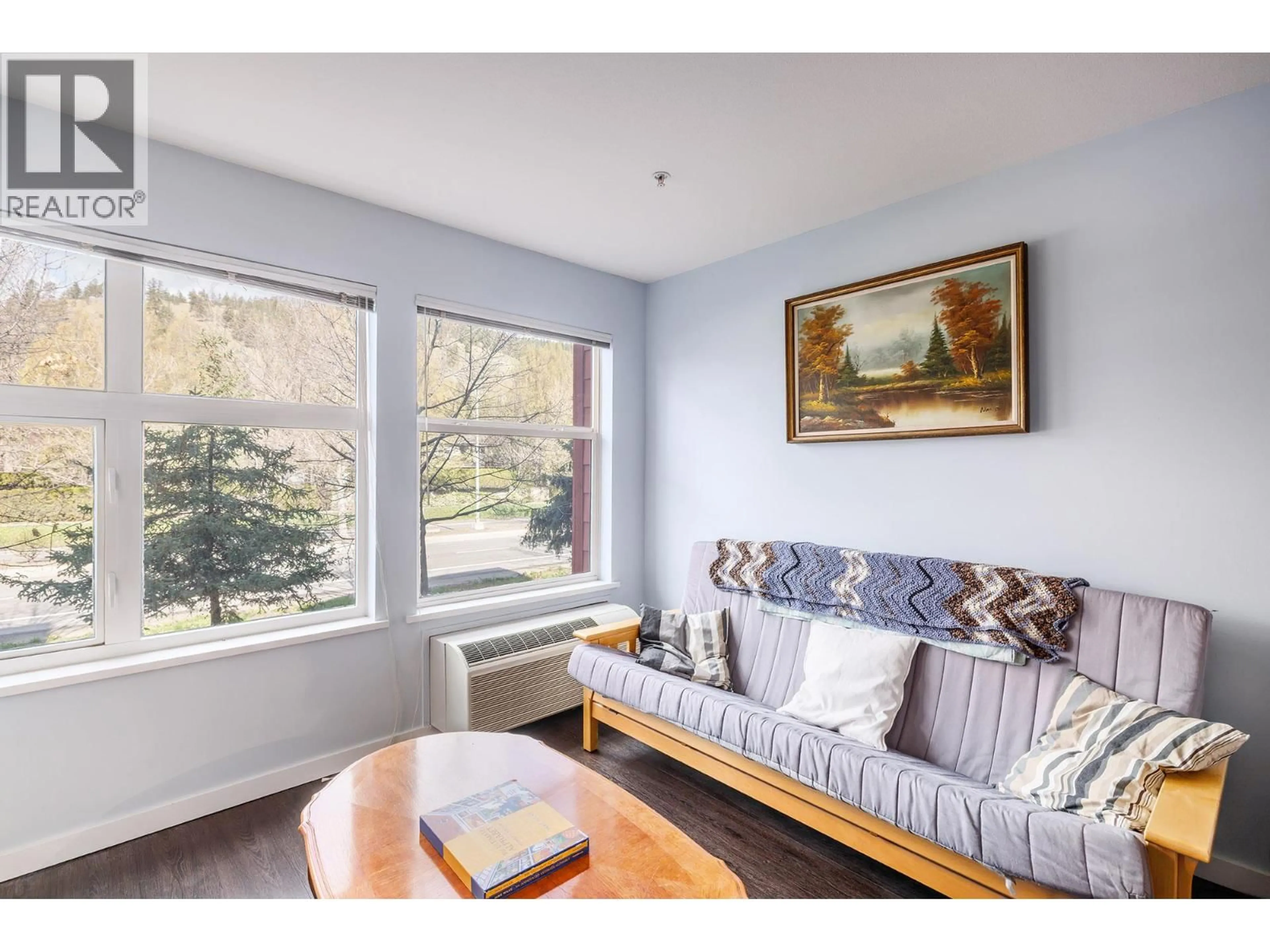 Living room with furniture, wood/laminate floor for 206 - 555 YATES ROAD, Kelowna British Columbia V1V2V2