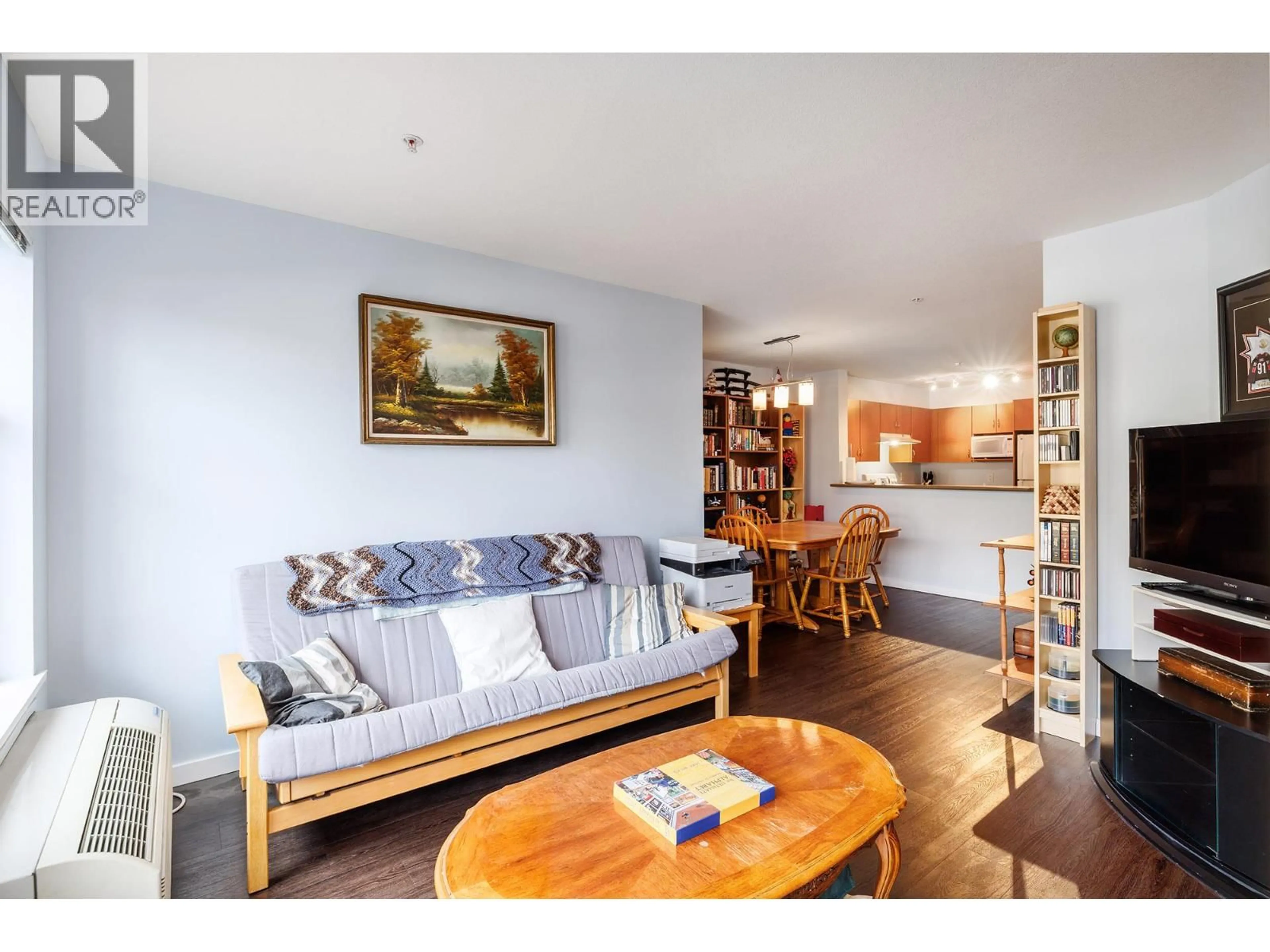 Living room with furniture, wood/laminate floor for 206 - 555 YATES ROAD, Kelowna British Columbia V1V2V2