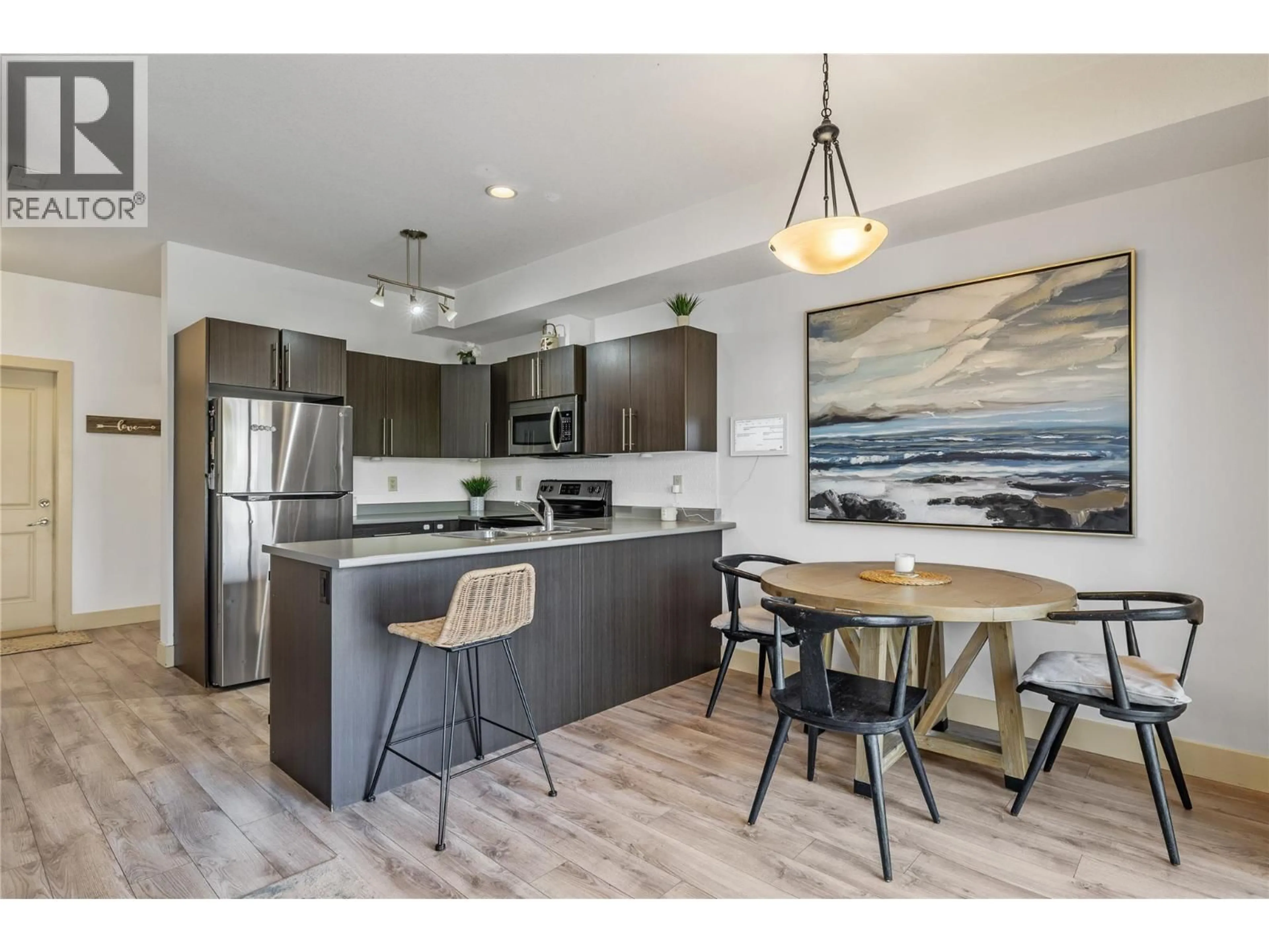 Open concept kitchen, wood/laminate floor for 4 - 335 GERSTMAR ROAD, Kelowna British Columbia V1X4A6