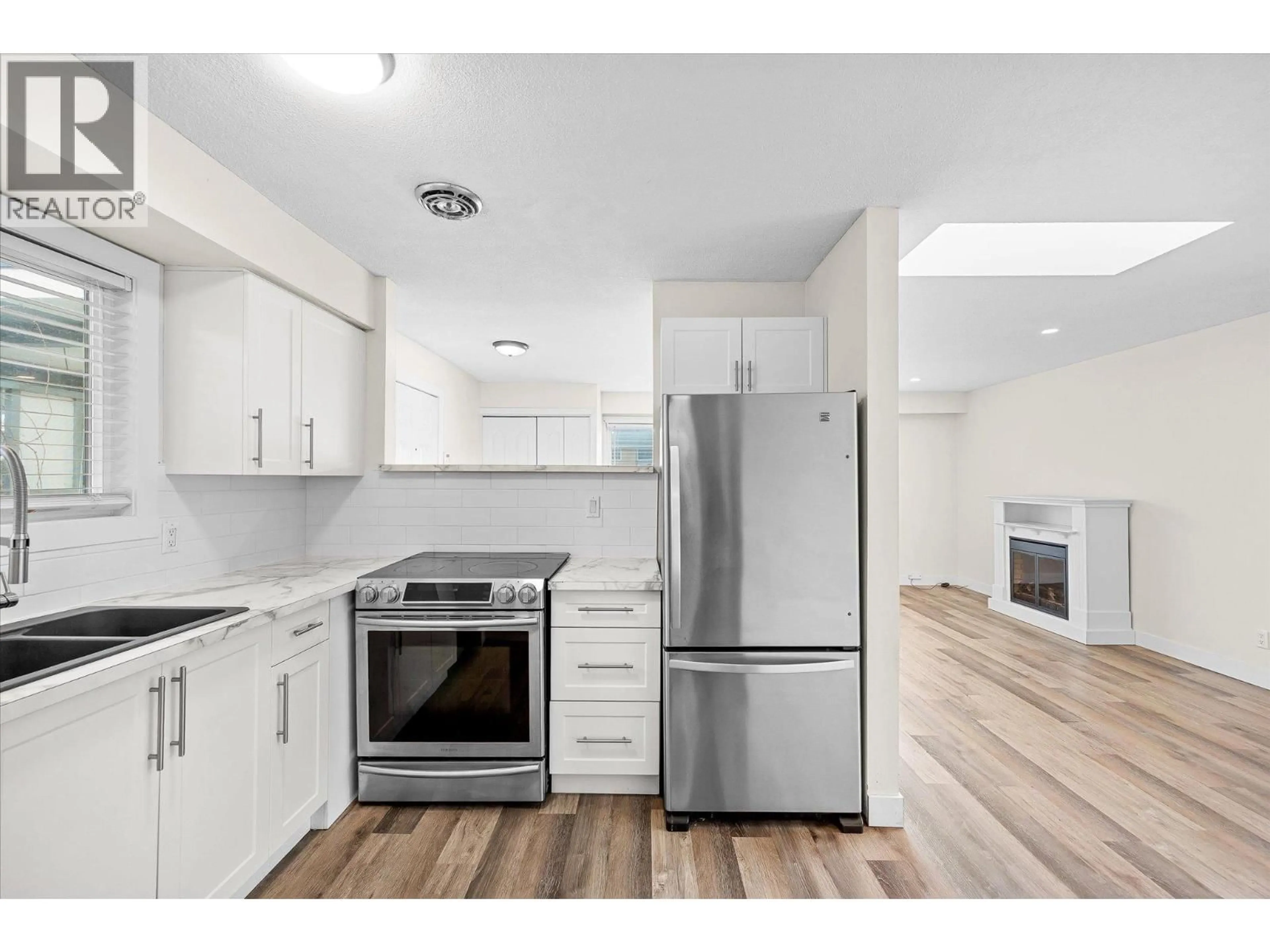 Open concept kitchen, wood/laminate floor for 740 RAYMER AVENUE, Kelowna British Columbia V1Y4Z8