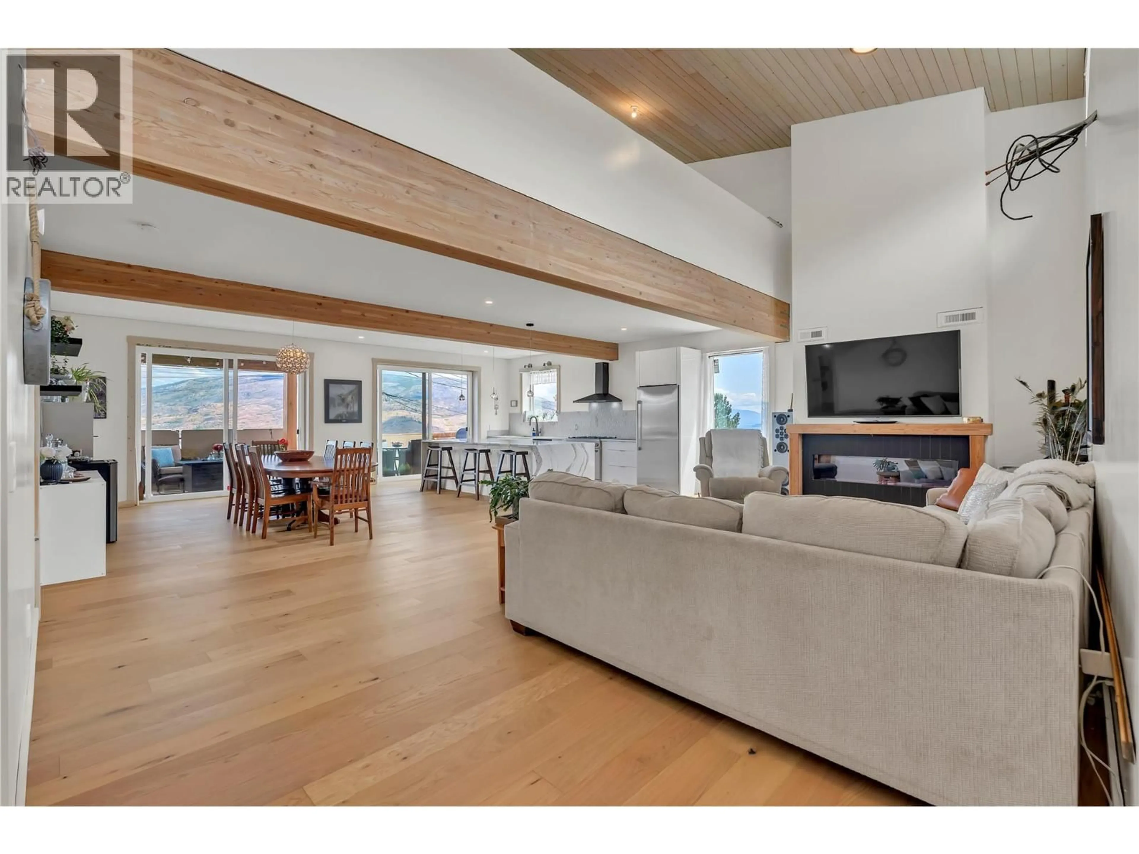 Living room with furniture, wood/laminate floor for 6074 JACKSON CRESCENT, Peachland British Columbia V0H1X4