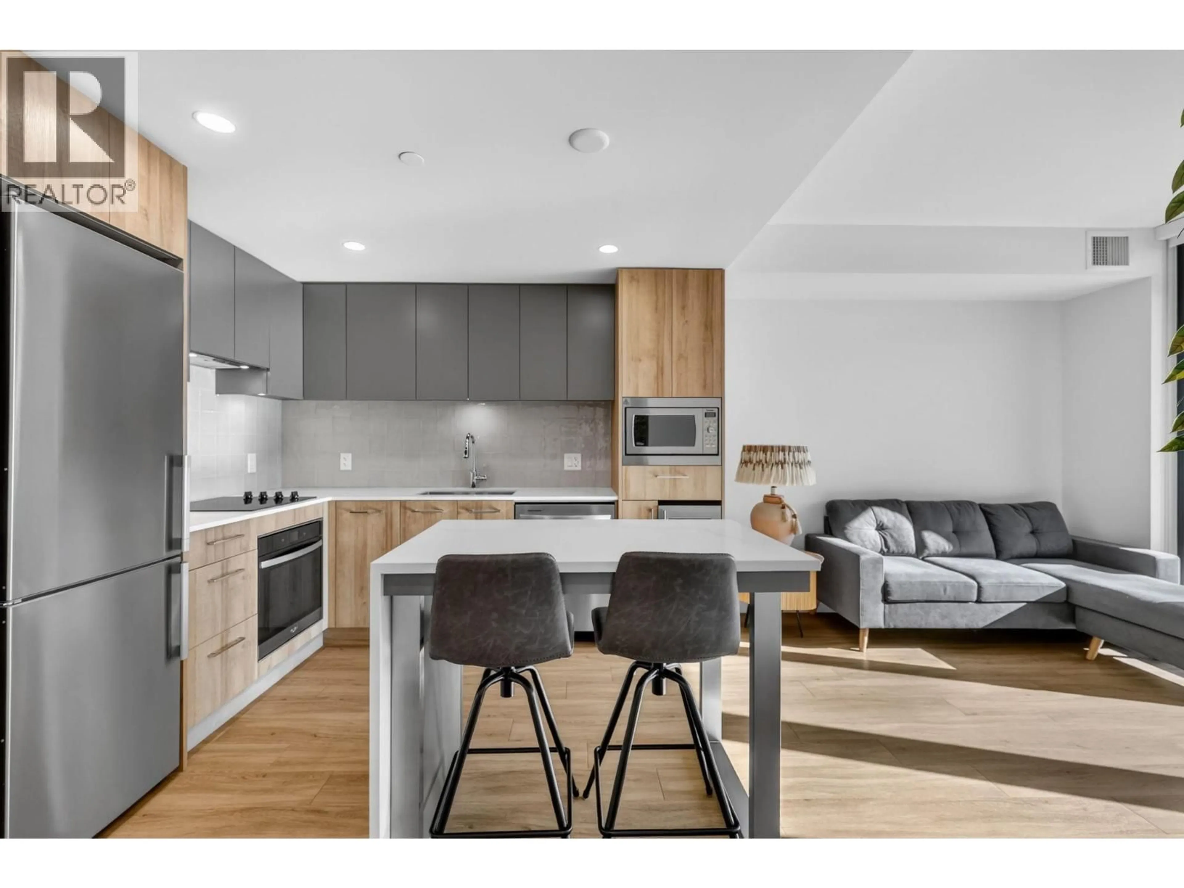 Open concept kitchen, wood/laminate floor for 703 - 3699 CAPOZZI ROAD, Kelowna British Columbia V1W3L2