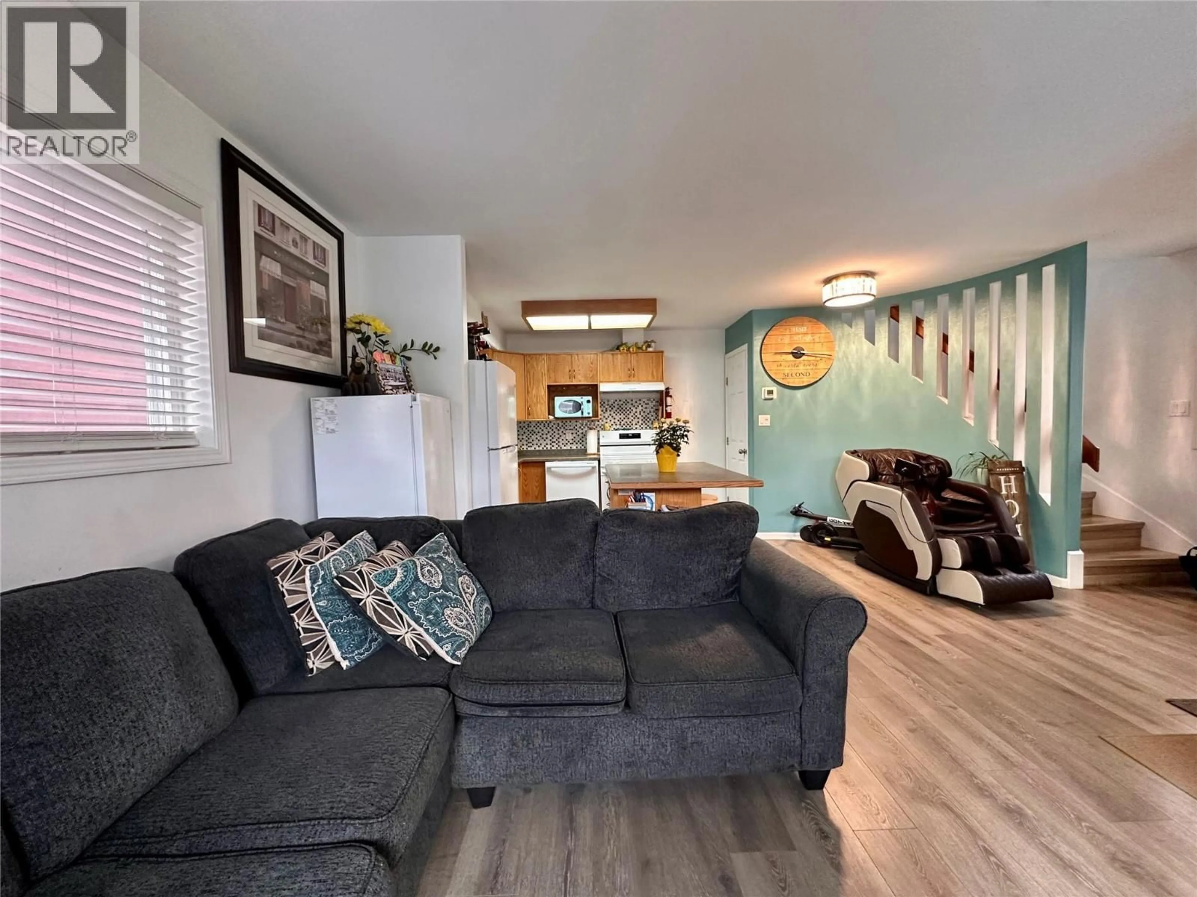 Living room with furniture, wood/laminate floor for 101 - 443 BRAID STREET, Penticton British Columbia V2A4Y2