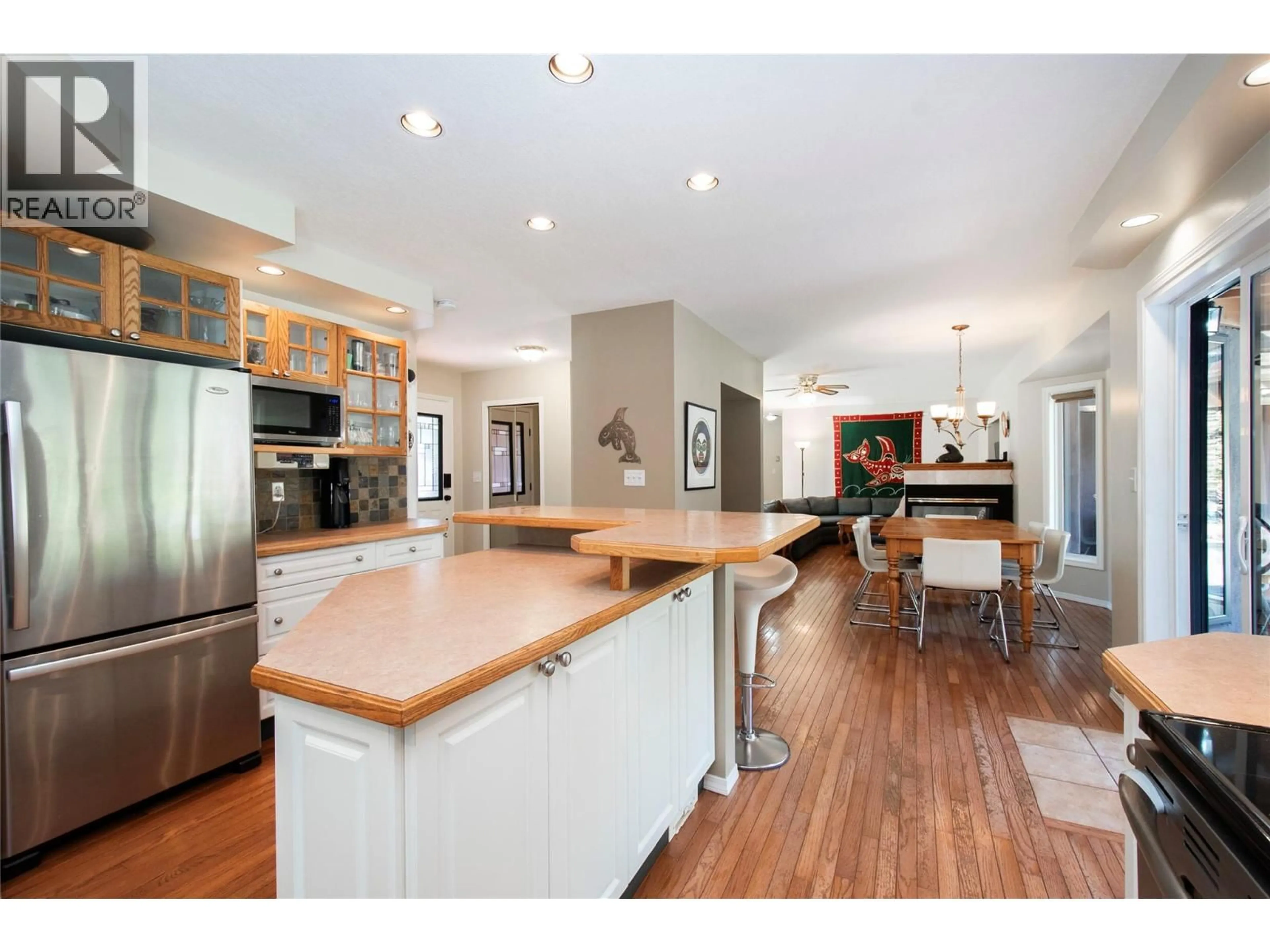 Open concept kitchen, wood/laminate floor for 916 POWELL BEACH ROAD, Summerland British Columbia V0H1Z9
