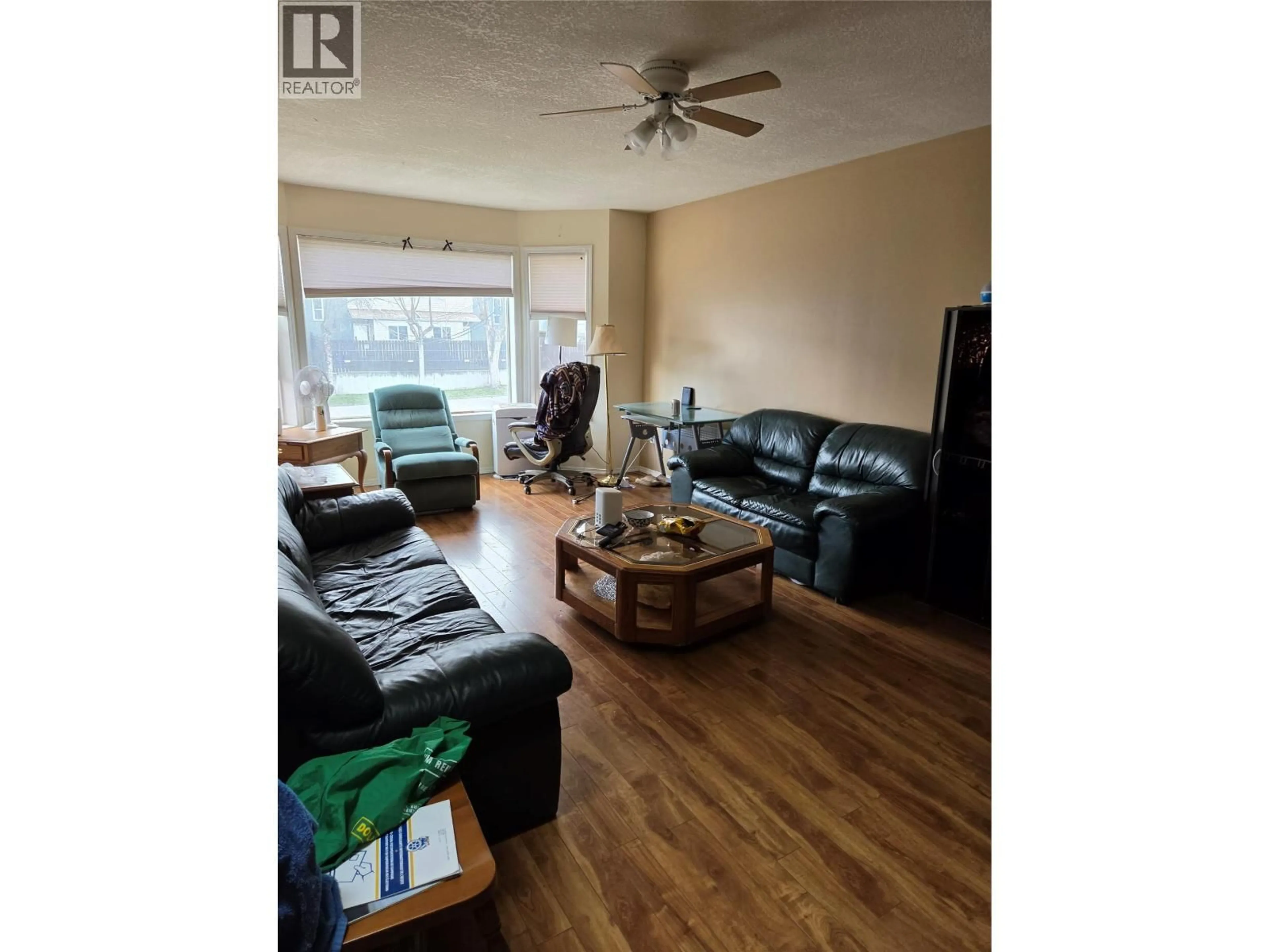 Living room with furniture, wood/laminate floor for 4012 19 STREET, Vernon British Columbia V1T7Y3