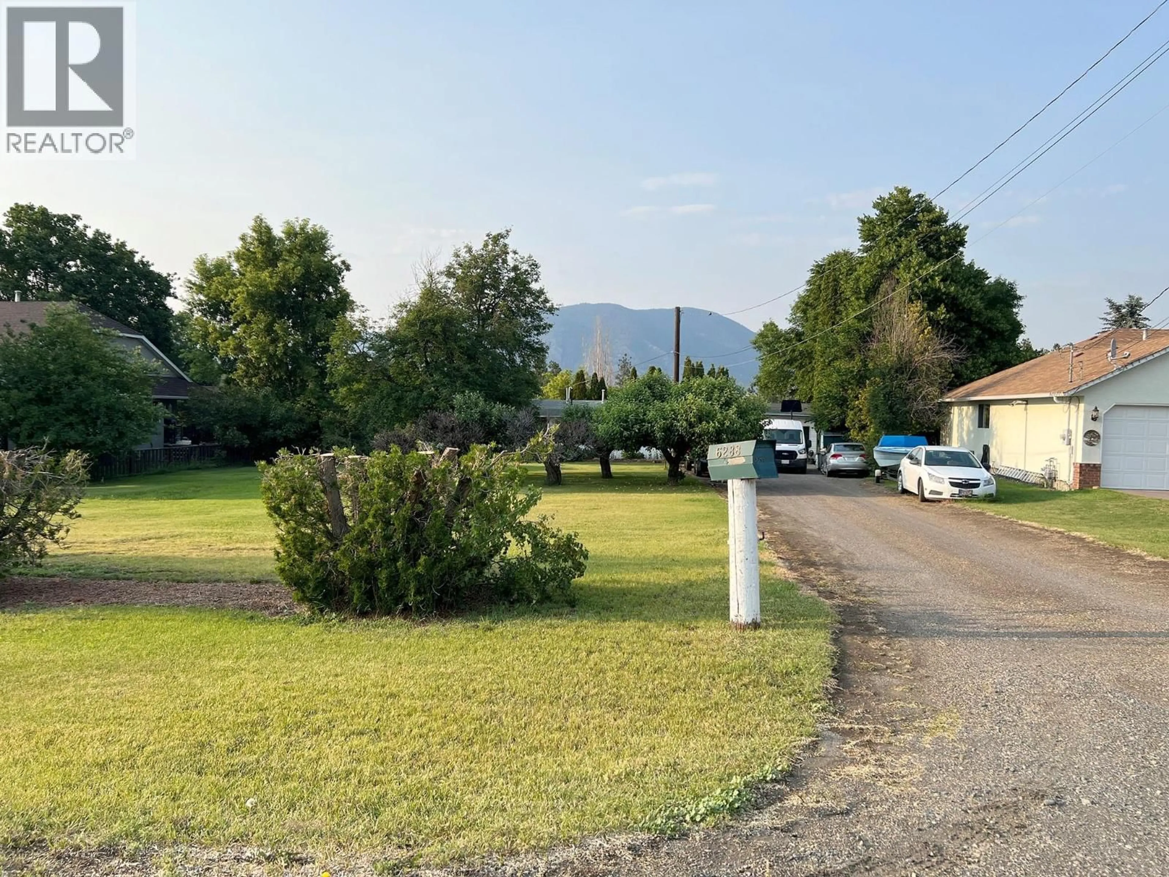 A pic from outside/outdoor area/front of a property/back of a property/a pic from drone, mountain view for 6288 MEADOWLAND CRESCENT NORTH, Kamloops British Columbia V2C5C2
