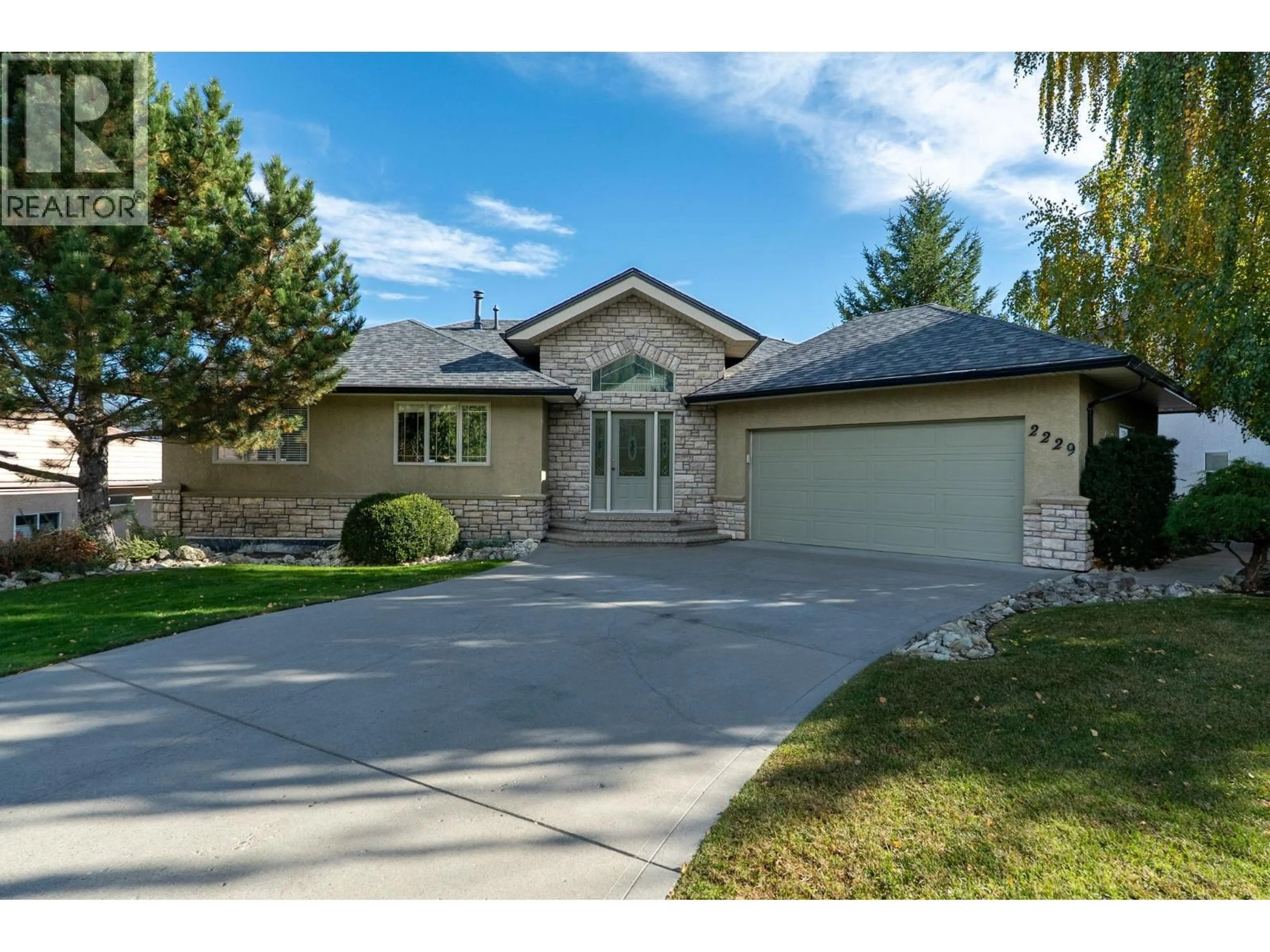 Home with vinyl exterior material, street for 2229 CAPISTRANO DRIVE, Kelowna British Columbia V1V2A2