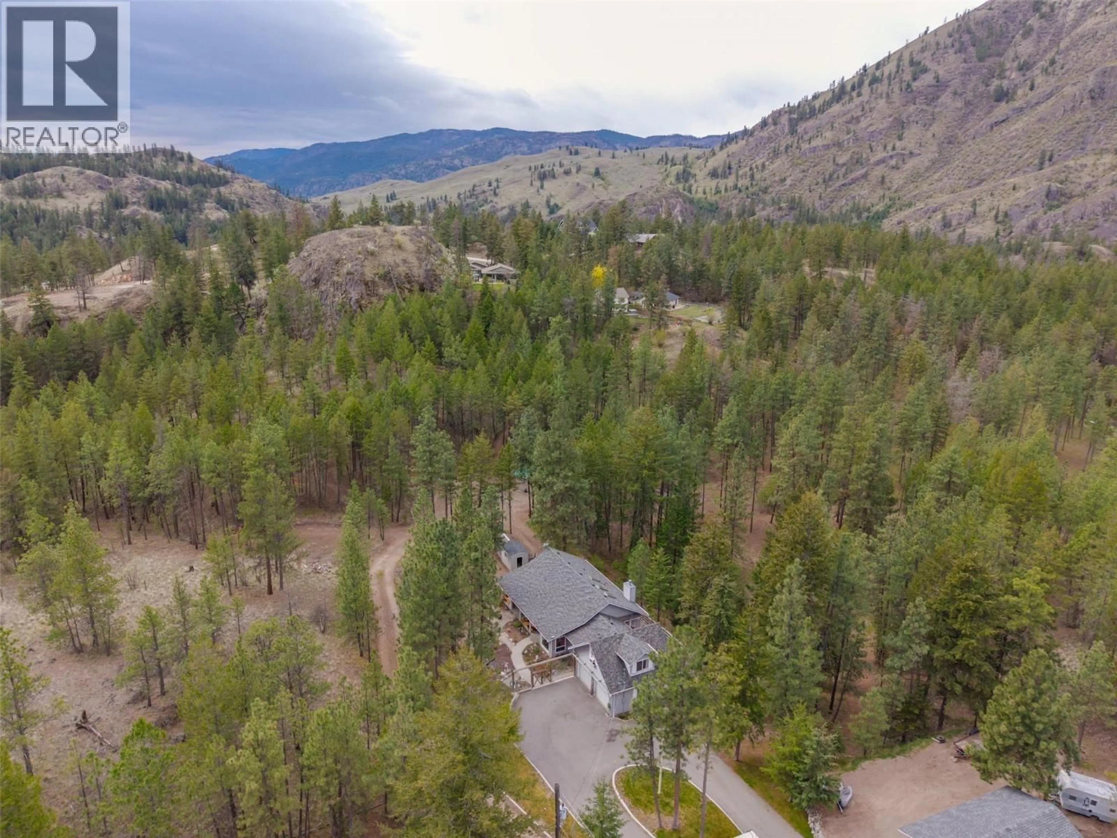 A pic from outside/outdoor area/front of a property/back of a property/a pic from drone, forest/trees view for 143 SADDLEHORN DRIVE, Kaleden British Columbia V0H1K0
