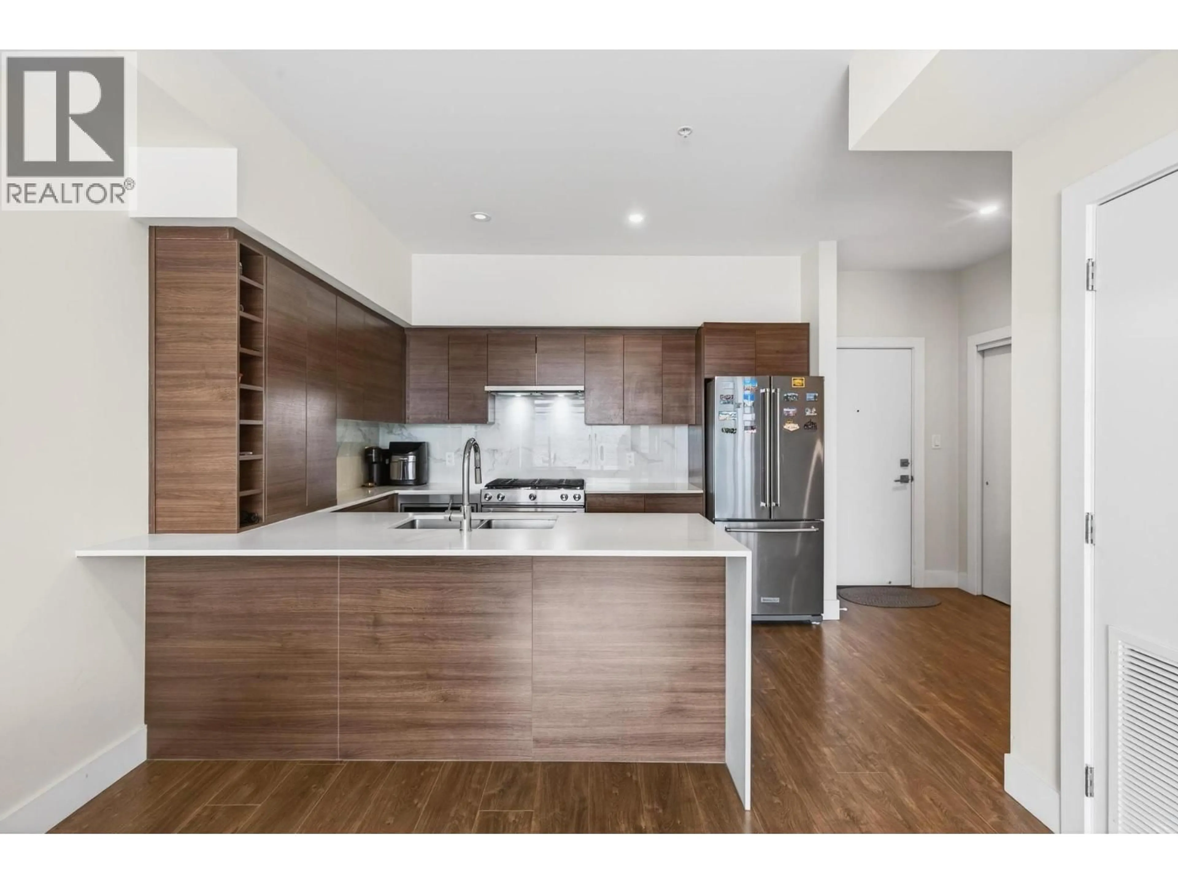 Open concept kitchen, wood/laminate floor for 412 - 1925 ENTERPRISE WAY, Kelowna British Columbia V1Y0J8